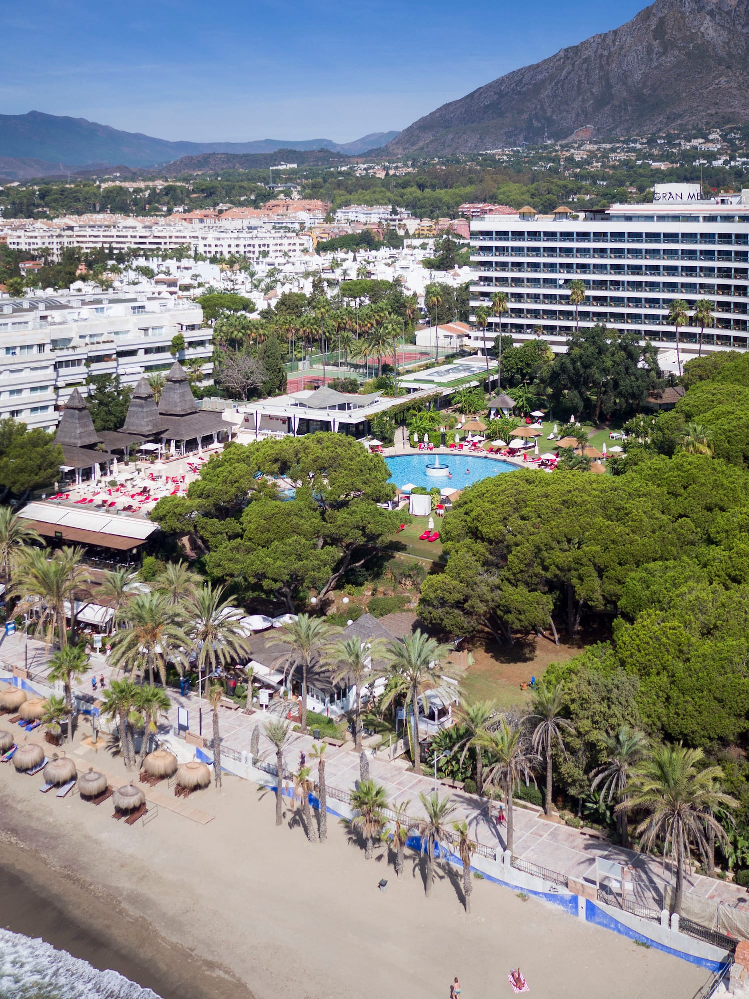 a beach with a swimming pool and trees