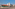 Hotel building exterior, red tile roof, balconies, Portuguese flag, parking.