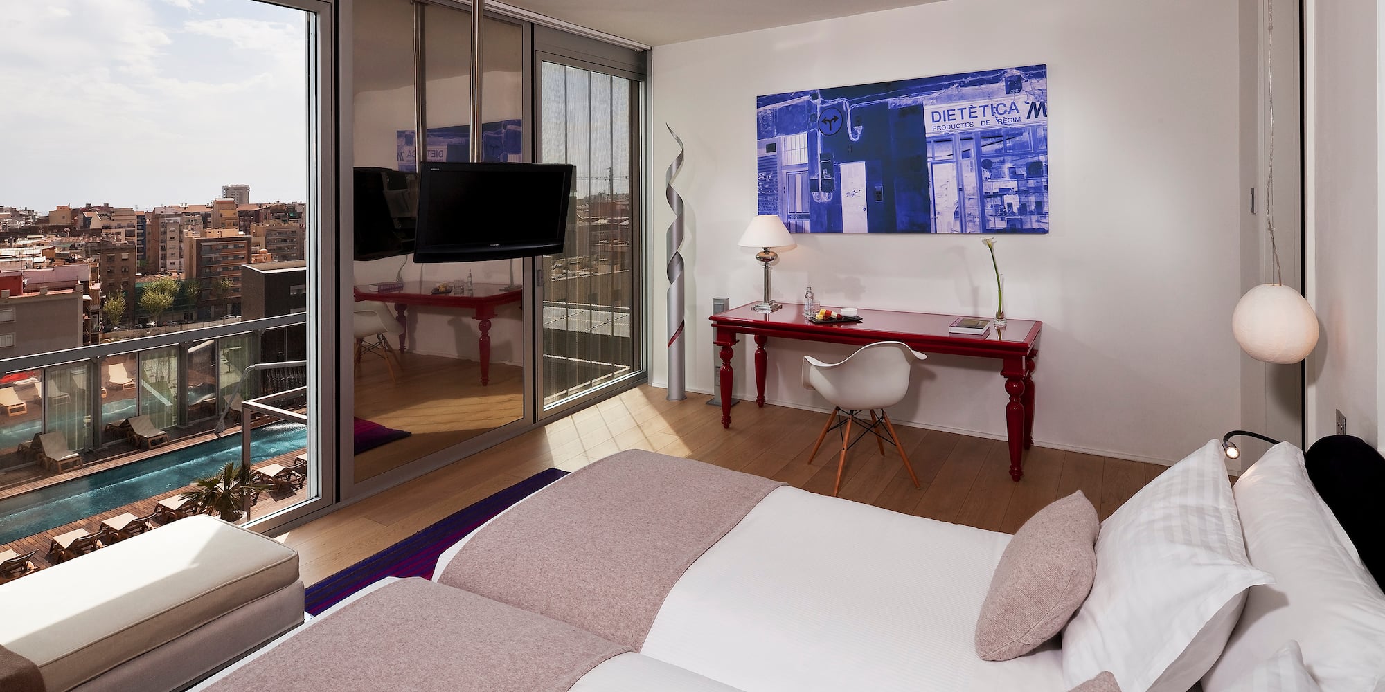 a bedroom with a large bed and a desk