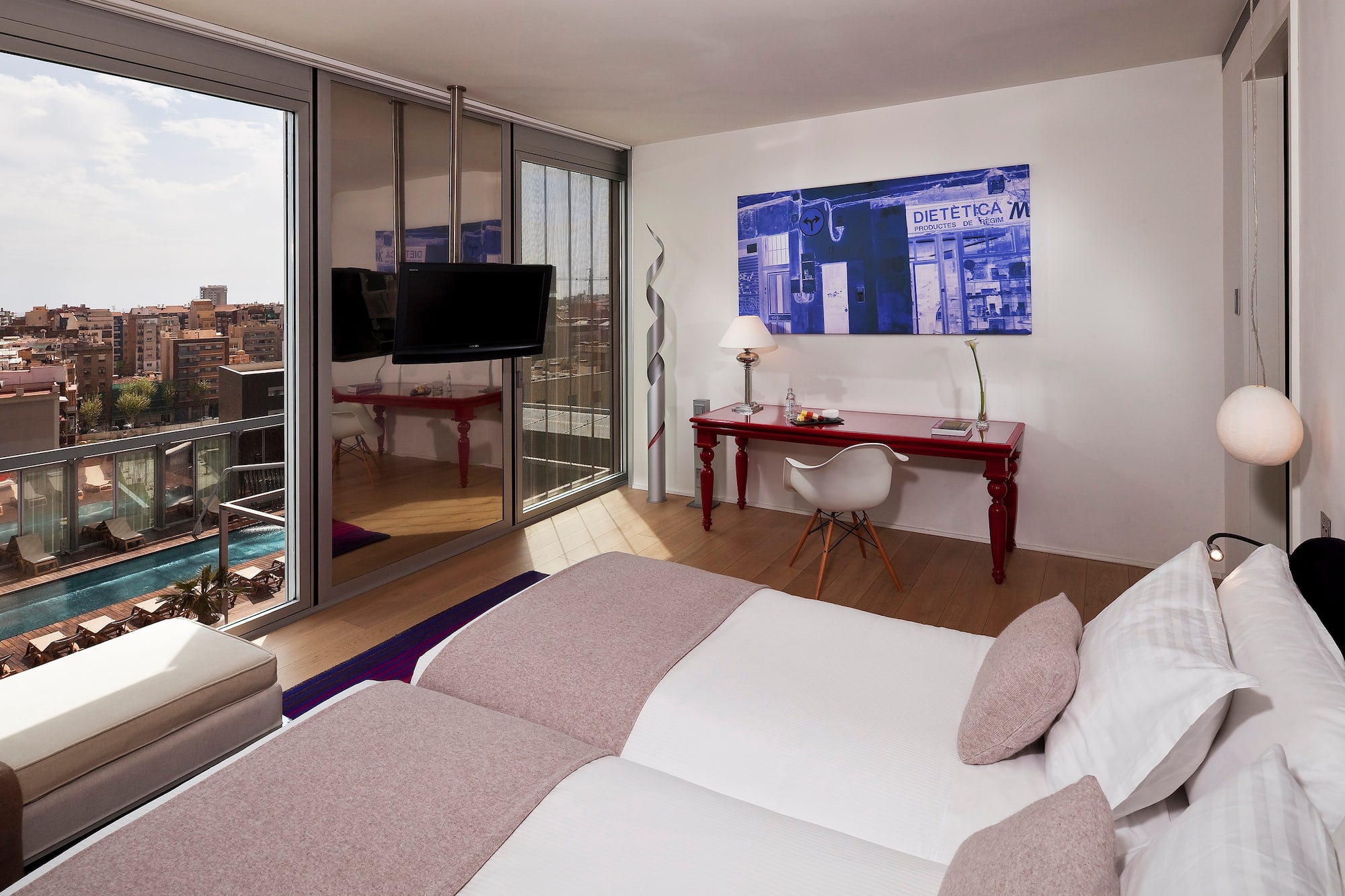 a bedroom with a large bed and a desk