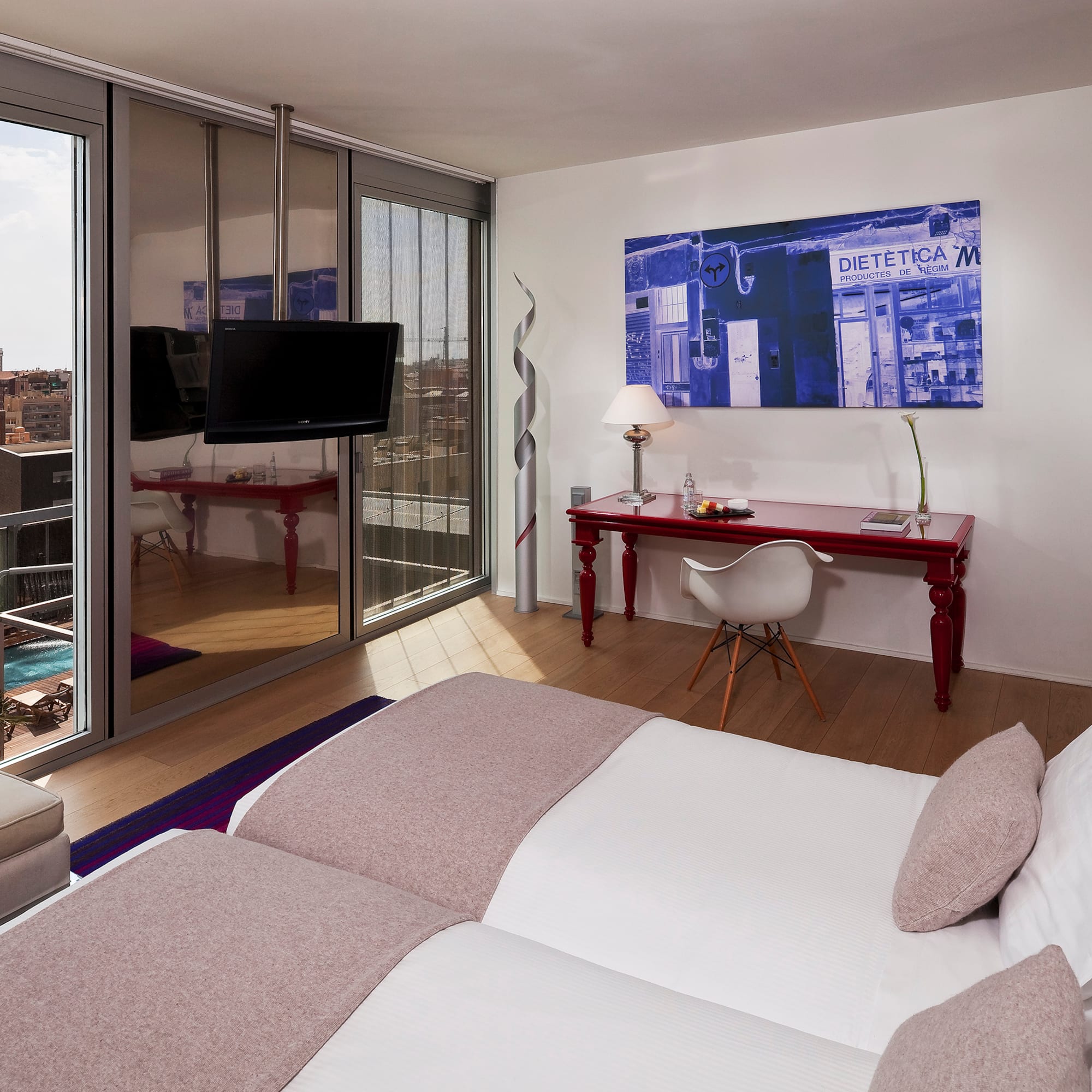 a bedroom with a large bed and a desk