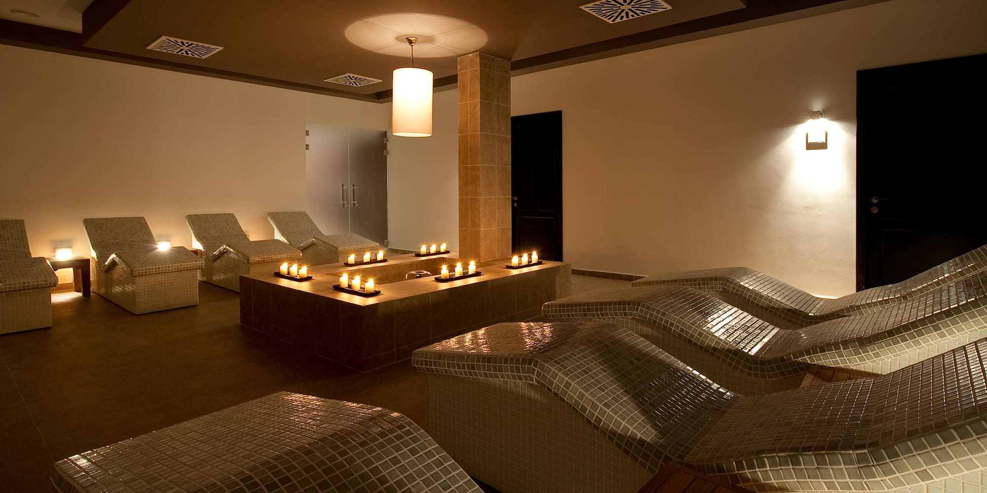 a room with chairs and candles