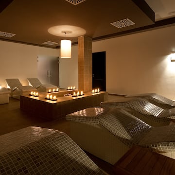 a room with chairs and candles