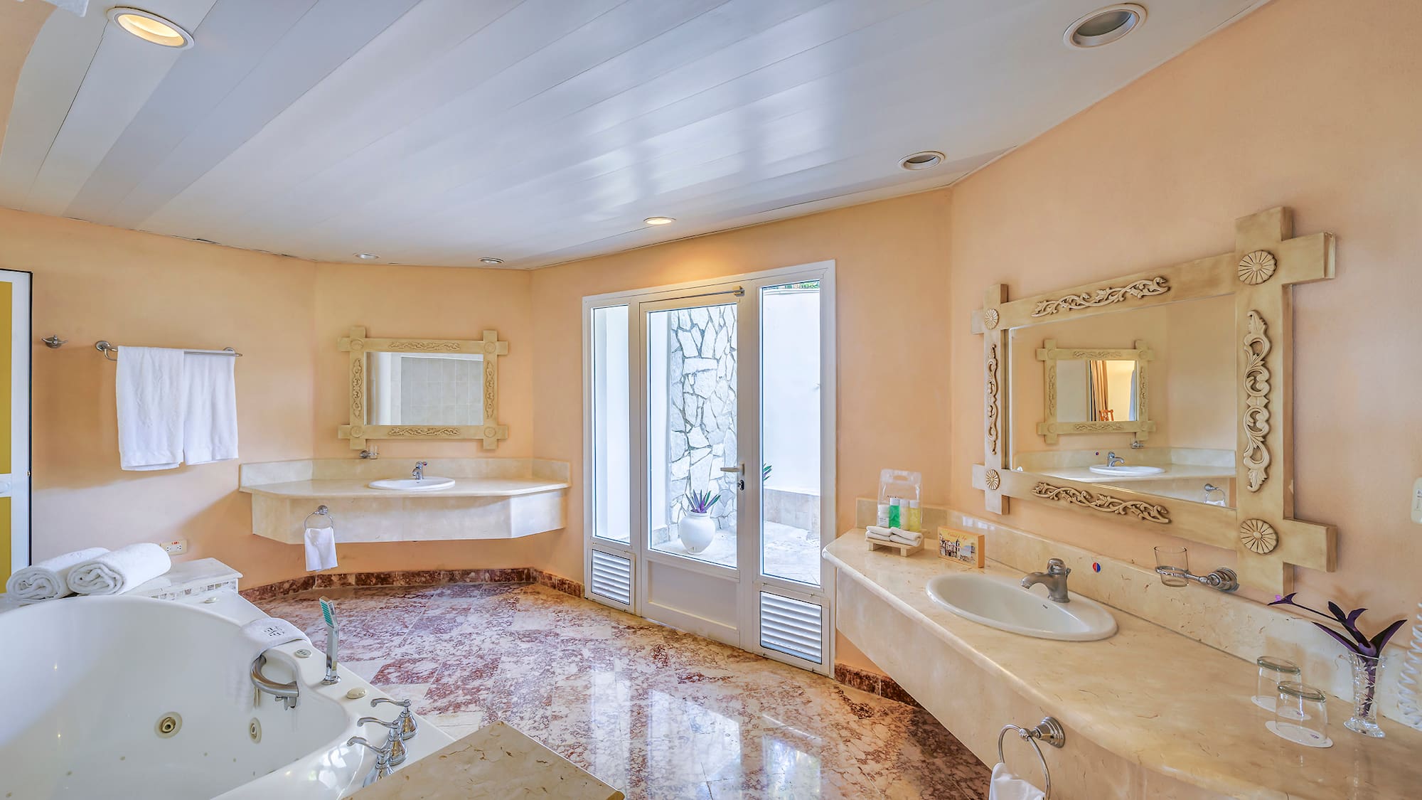 a bathroom with marble countertops and sinks