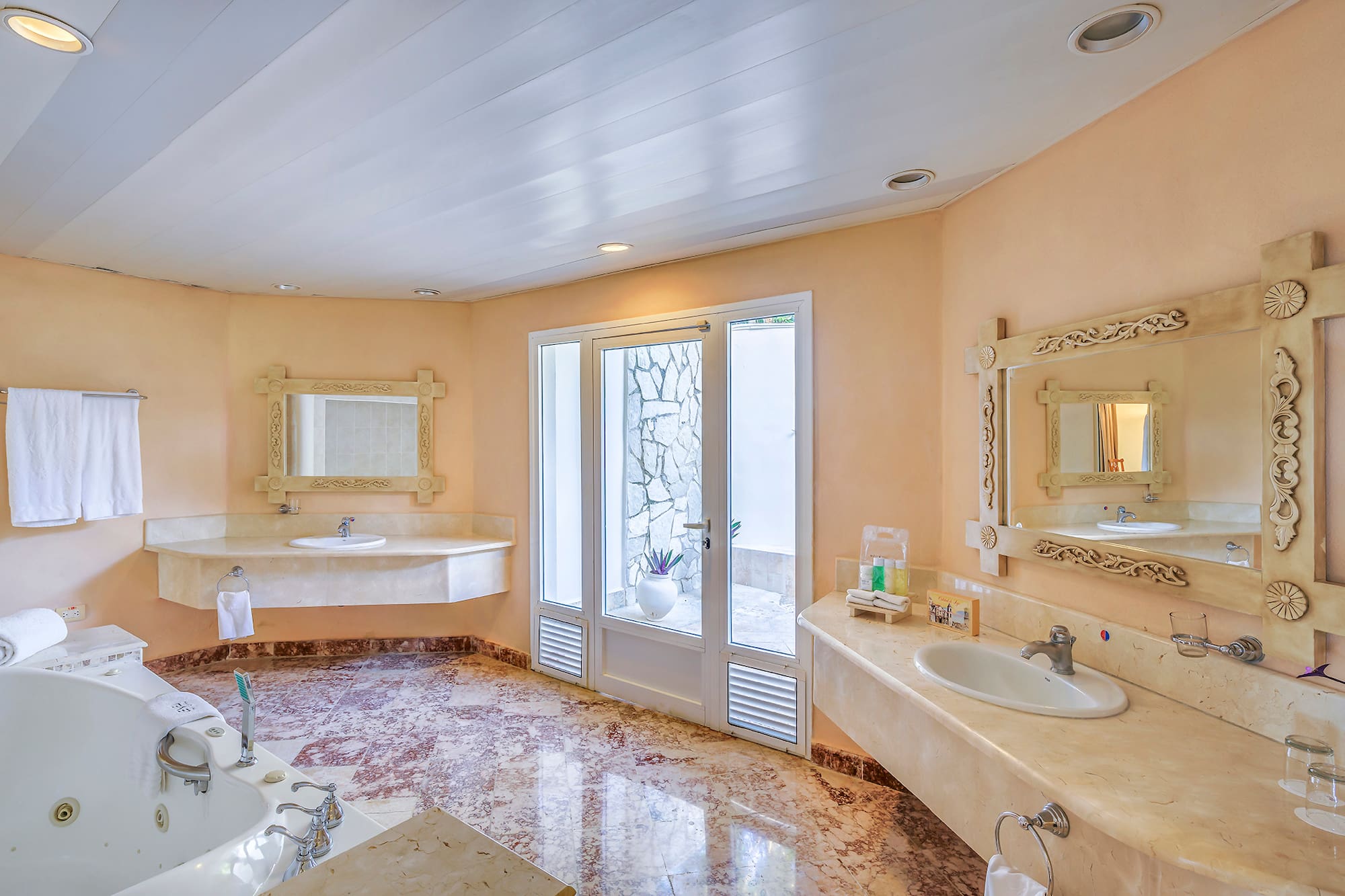 a bathroom with marble countertops and sinks