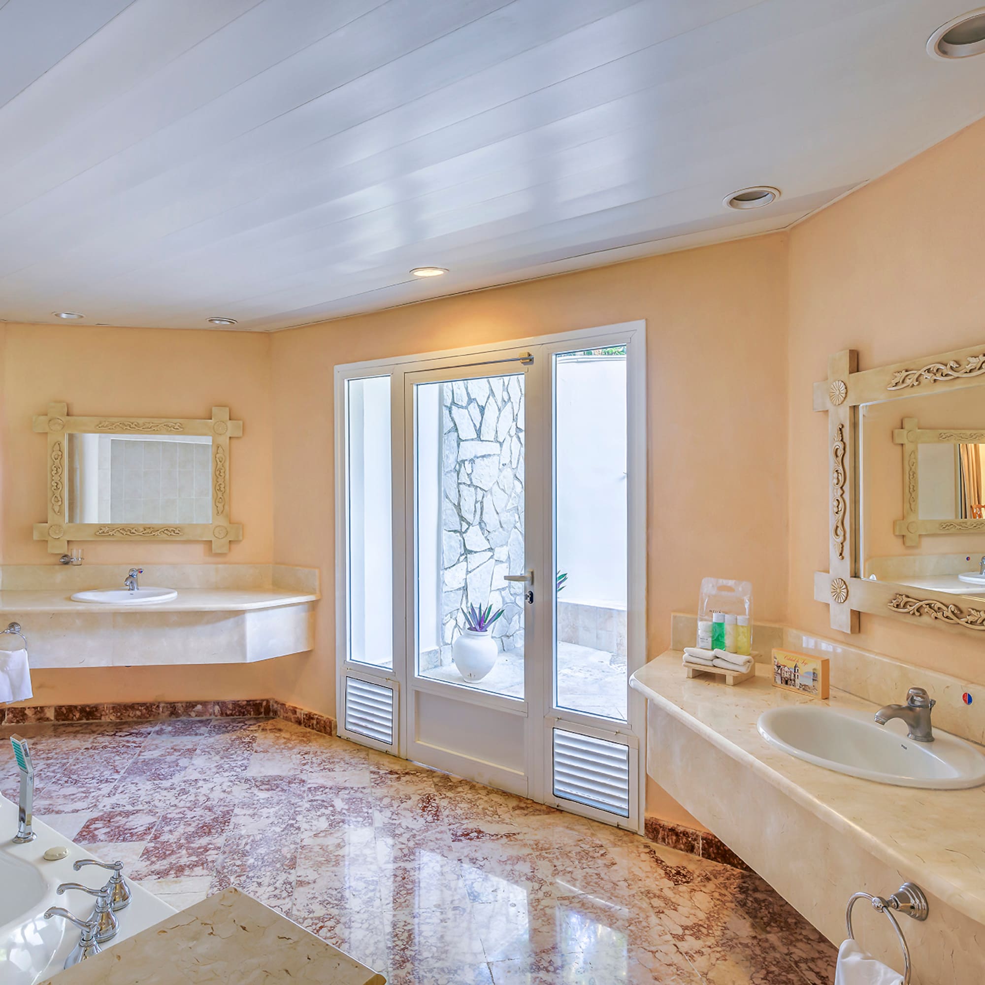 a bathroom with marble countertops and sinks