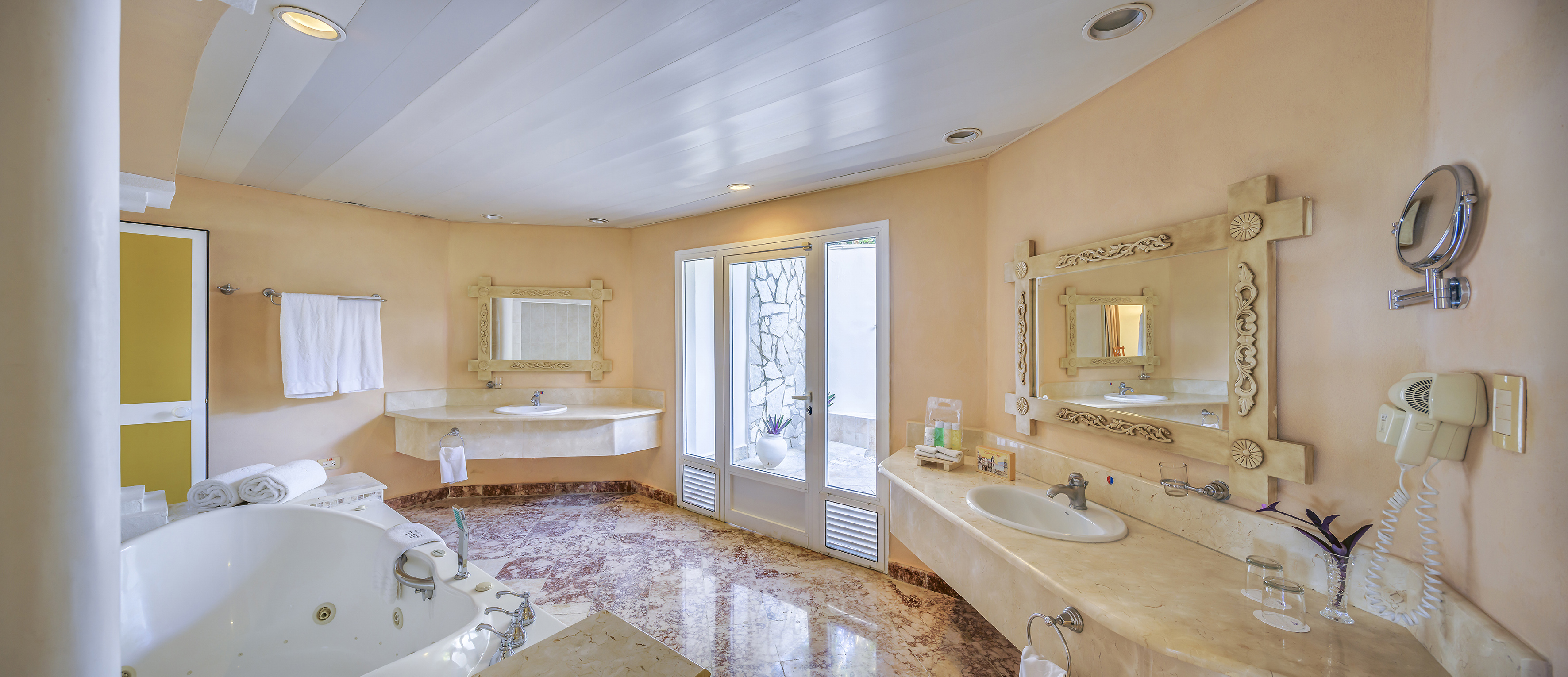 a bathroom with marble countertops and sinks