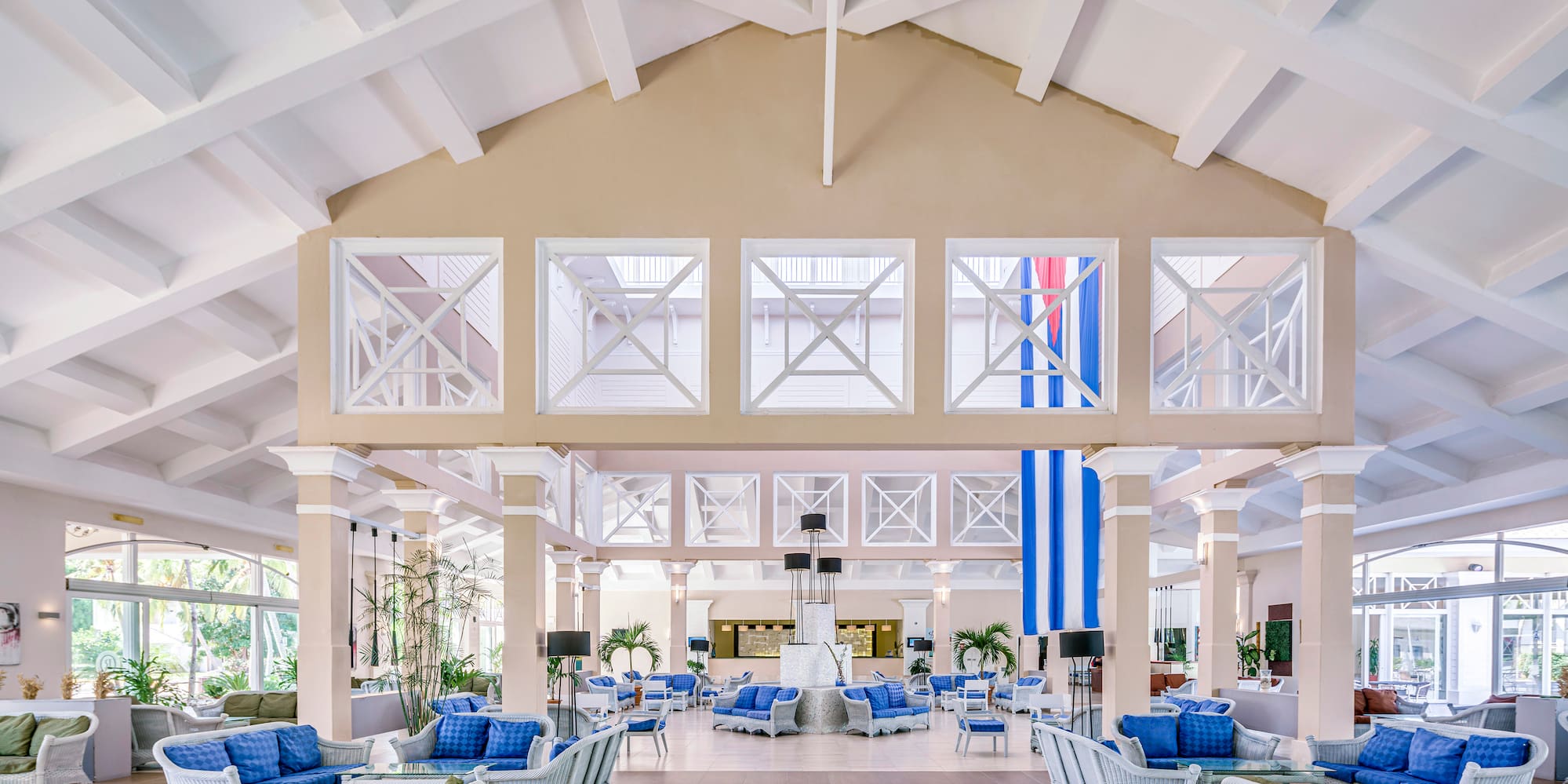a large room with white walls and blue furniture