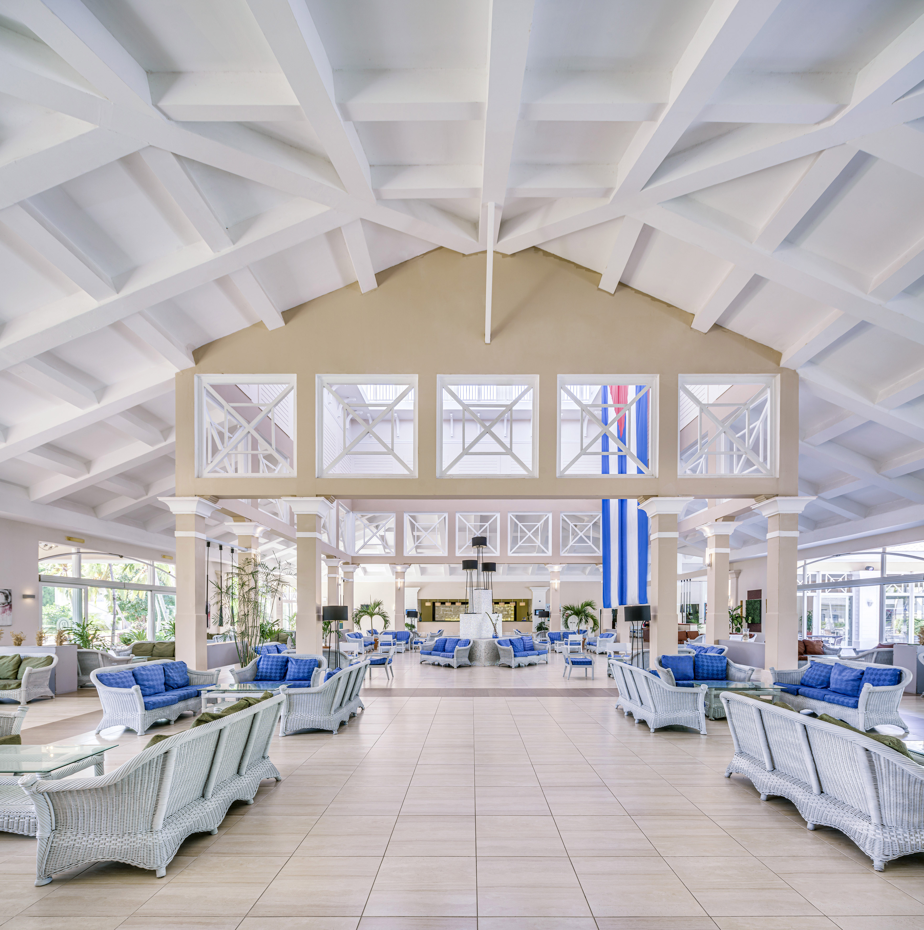 a large room with white walls and blue furniture