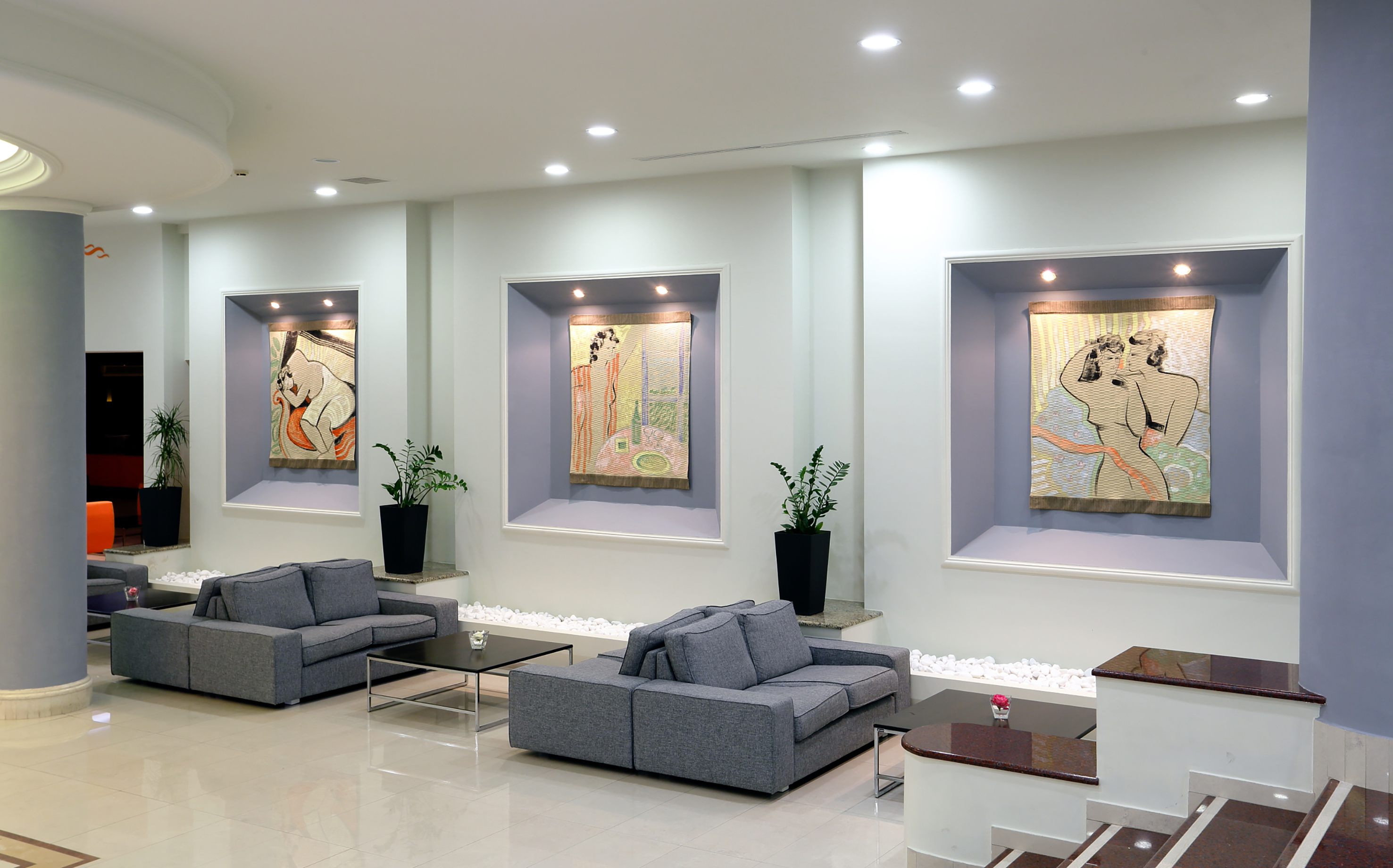 a room with couches and art on the wall
