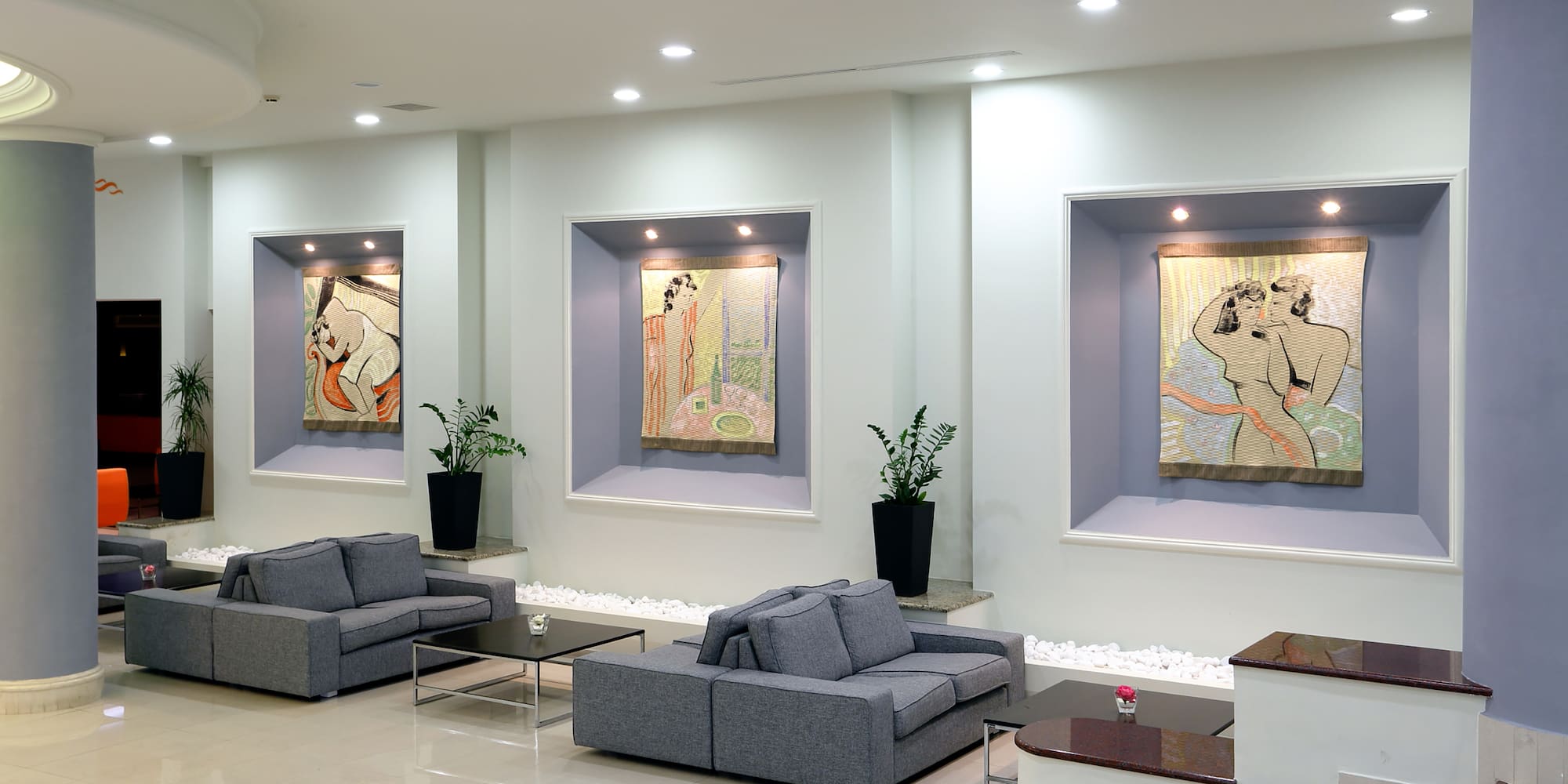 a room with couches and art on the wall