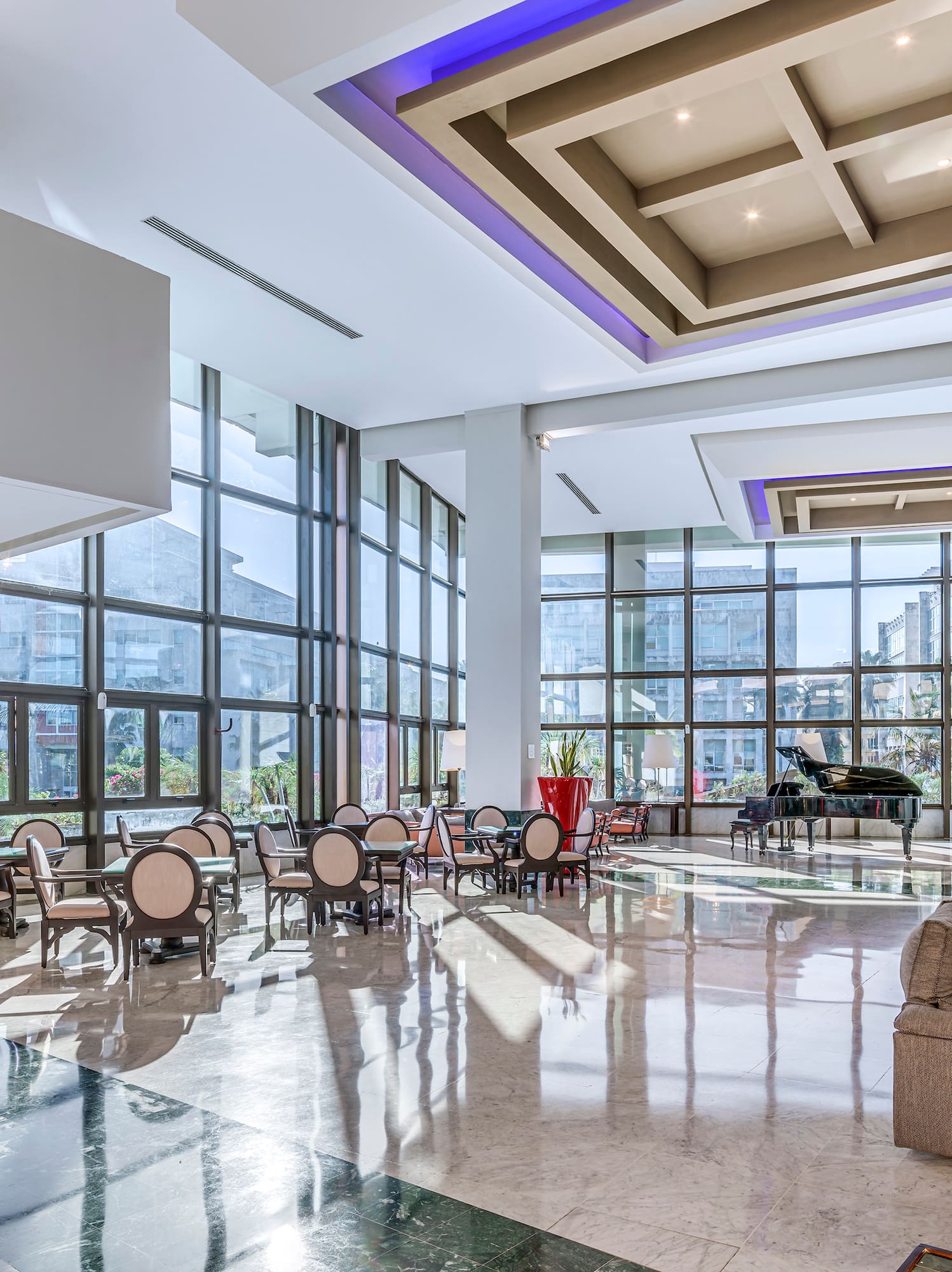 a large room with a piano and chairs