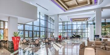 a large room with a piano and chairs