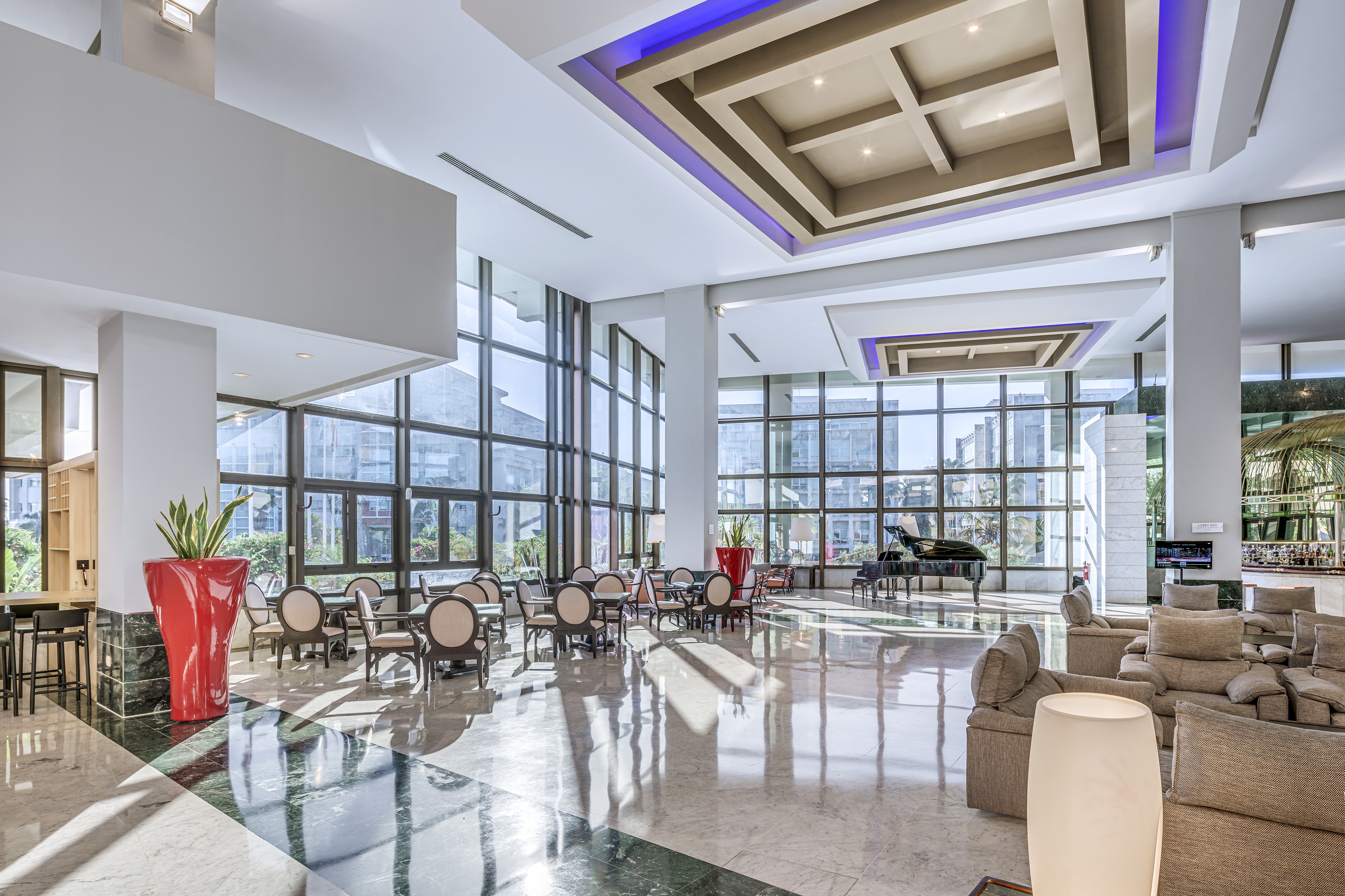 a large room with a piano and chairs