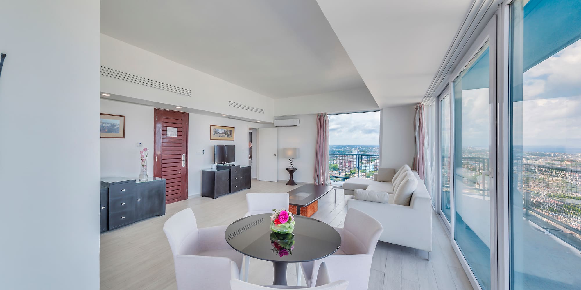 a living room with a table and chairs