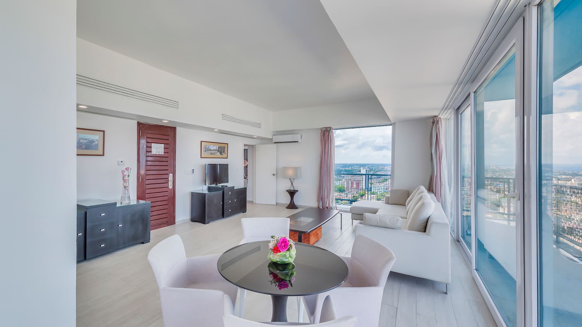 a living room with a table and chairs
