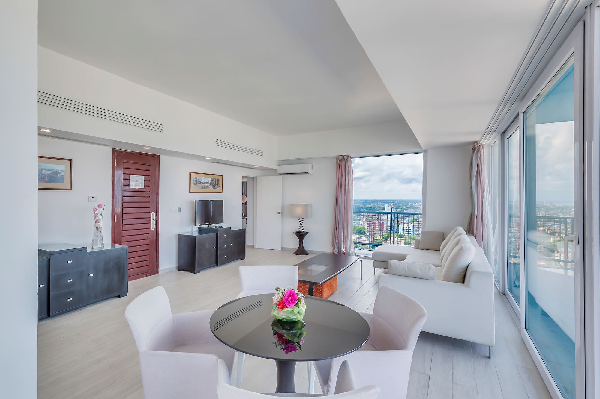 a living room with a table and chairs