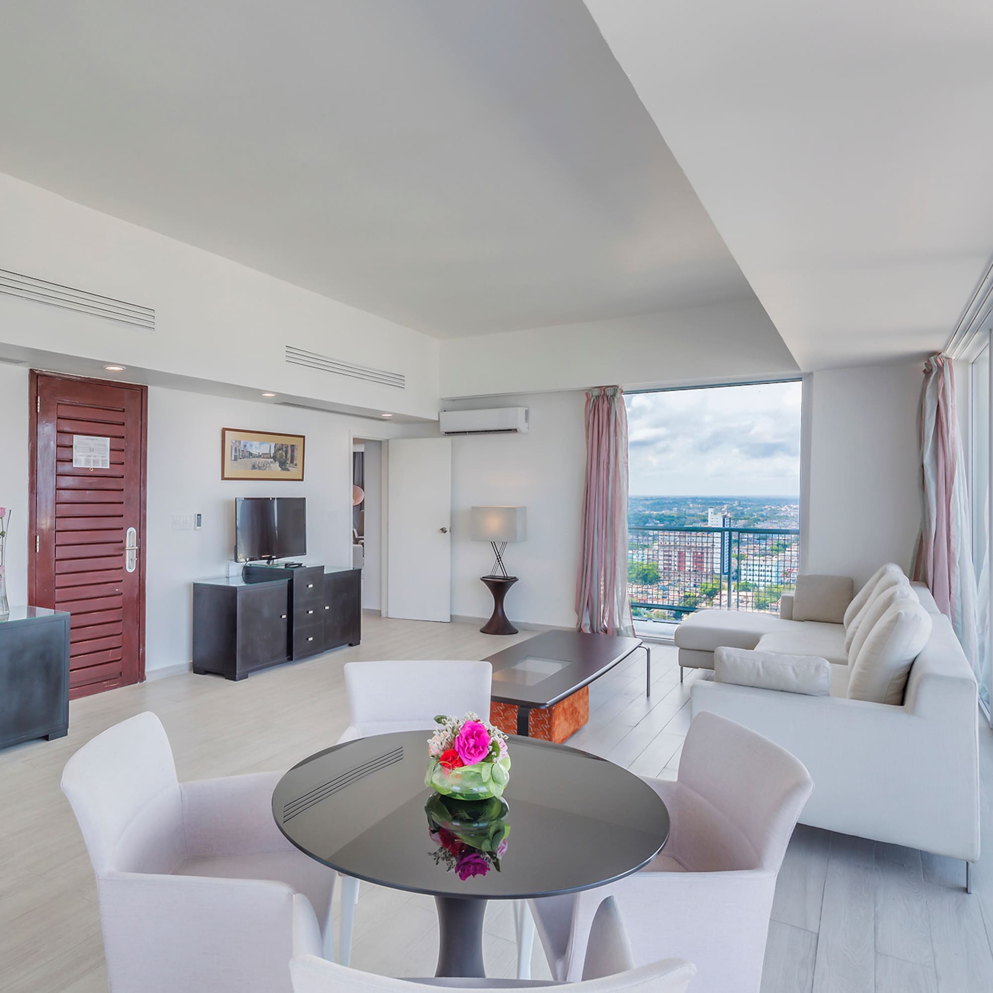 a living room with a table and chairs