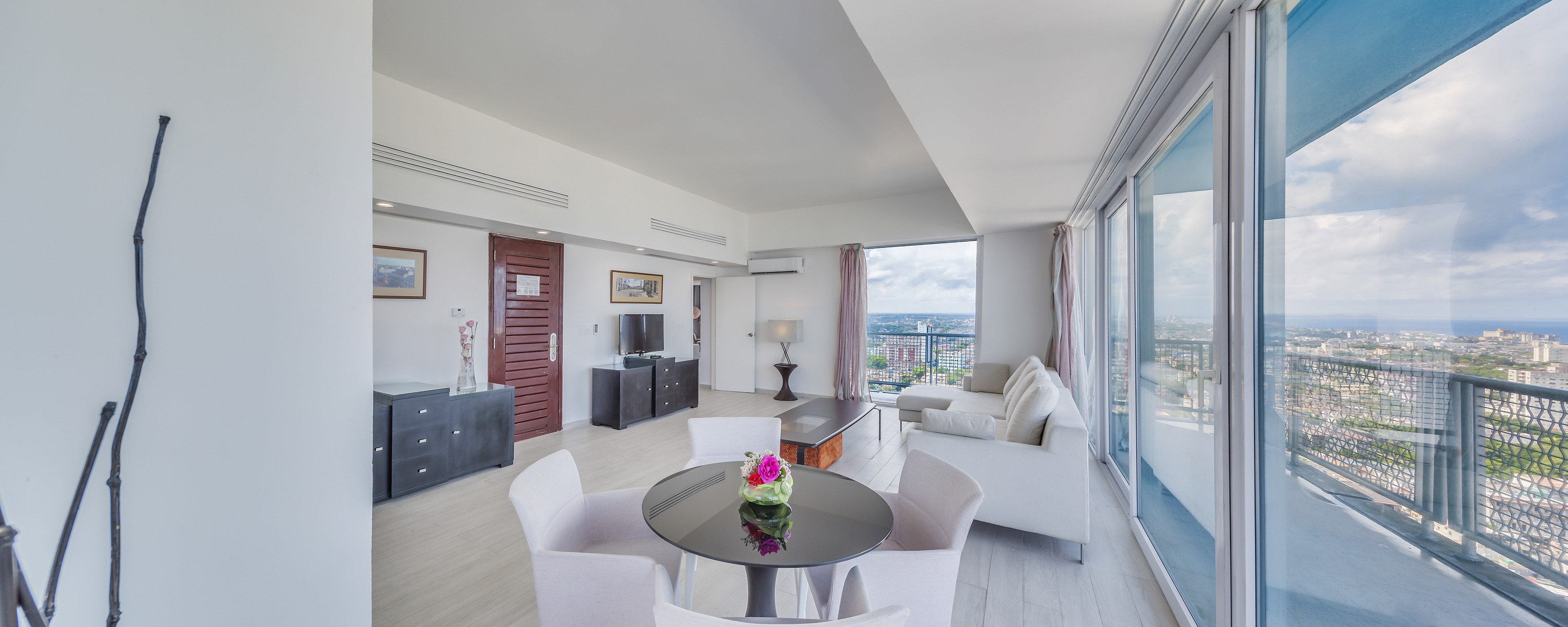 a living room with a table and chairs