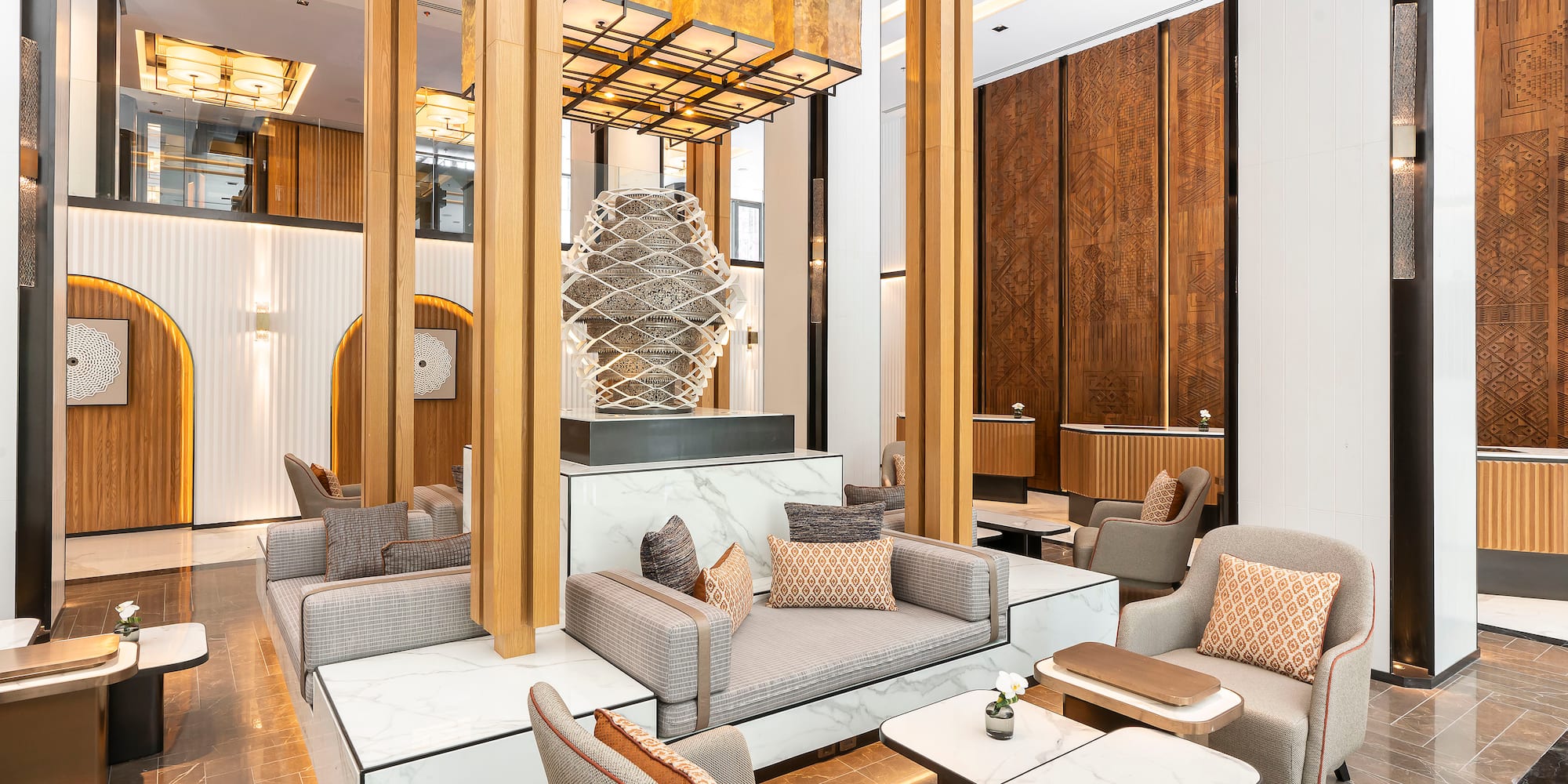 a room with a large chandelier and a couch