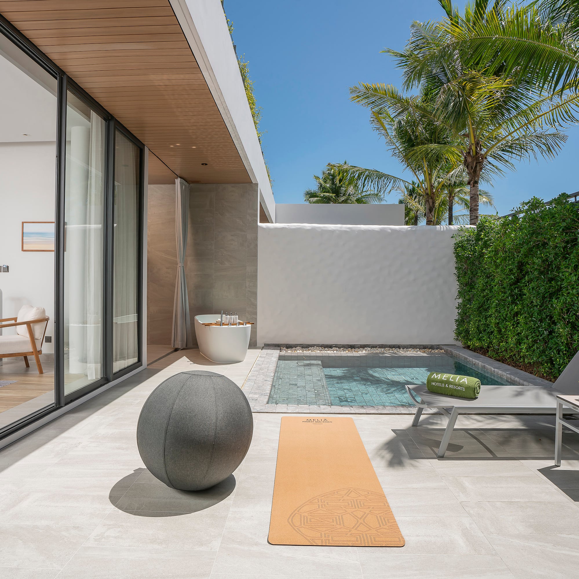 a pool and a yoga mat on a patio