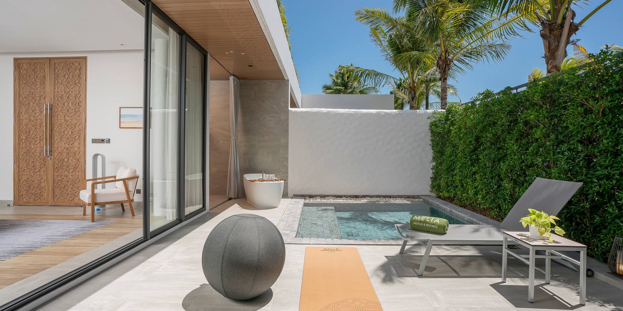 a pool and a yoga mat on a patio