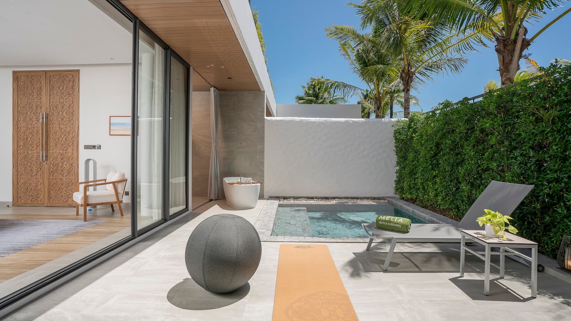 a pool and a yoga mat on a patio