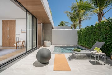 a pool and a yoga mat on a patio