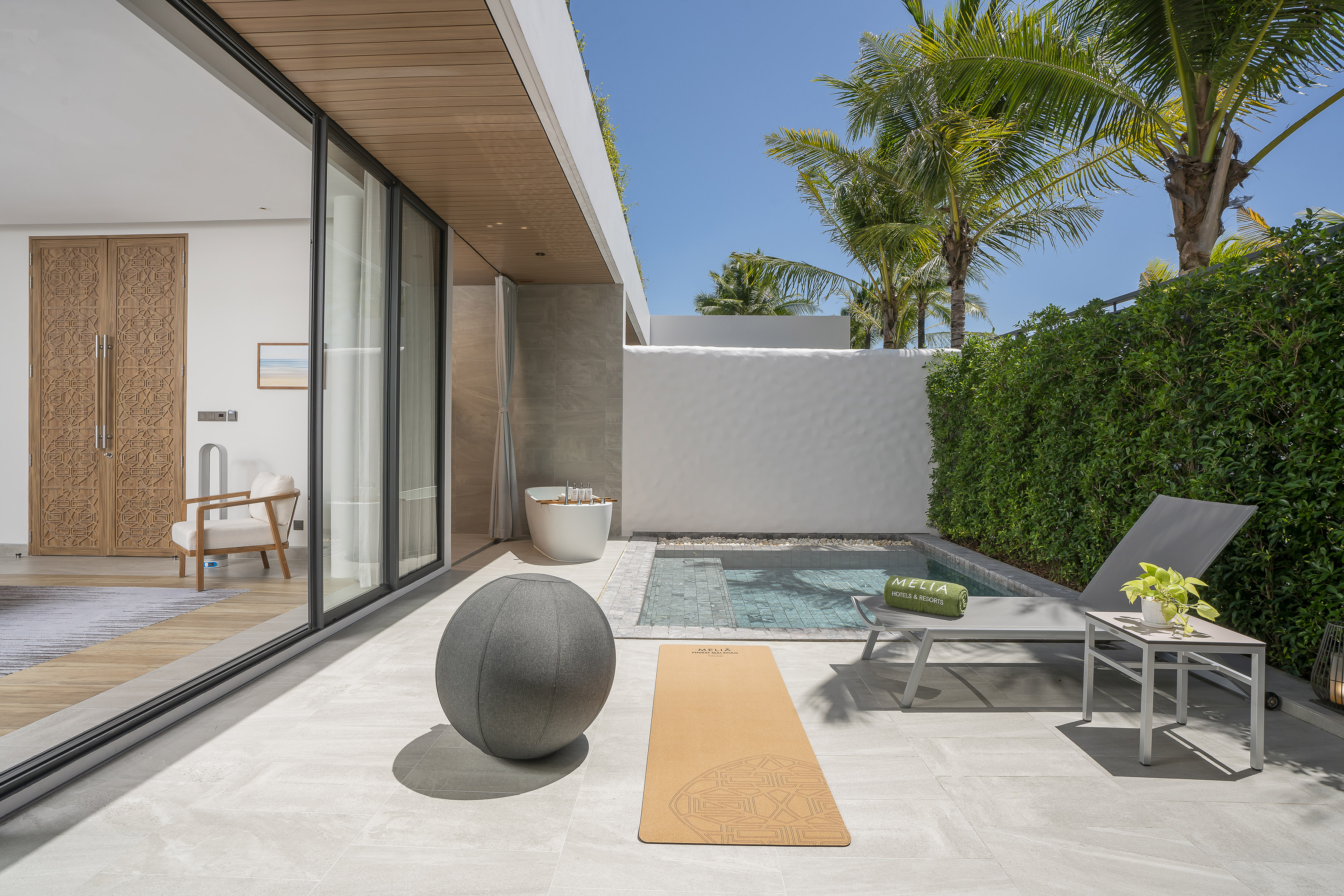 Meliá resort terrace with private plunge pool, yoga mat, and outdoor bath.