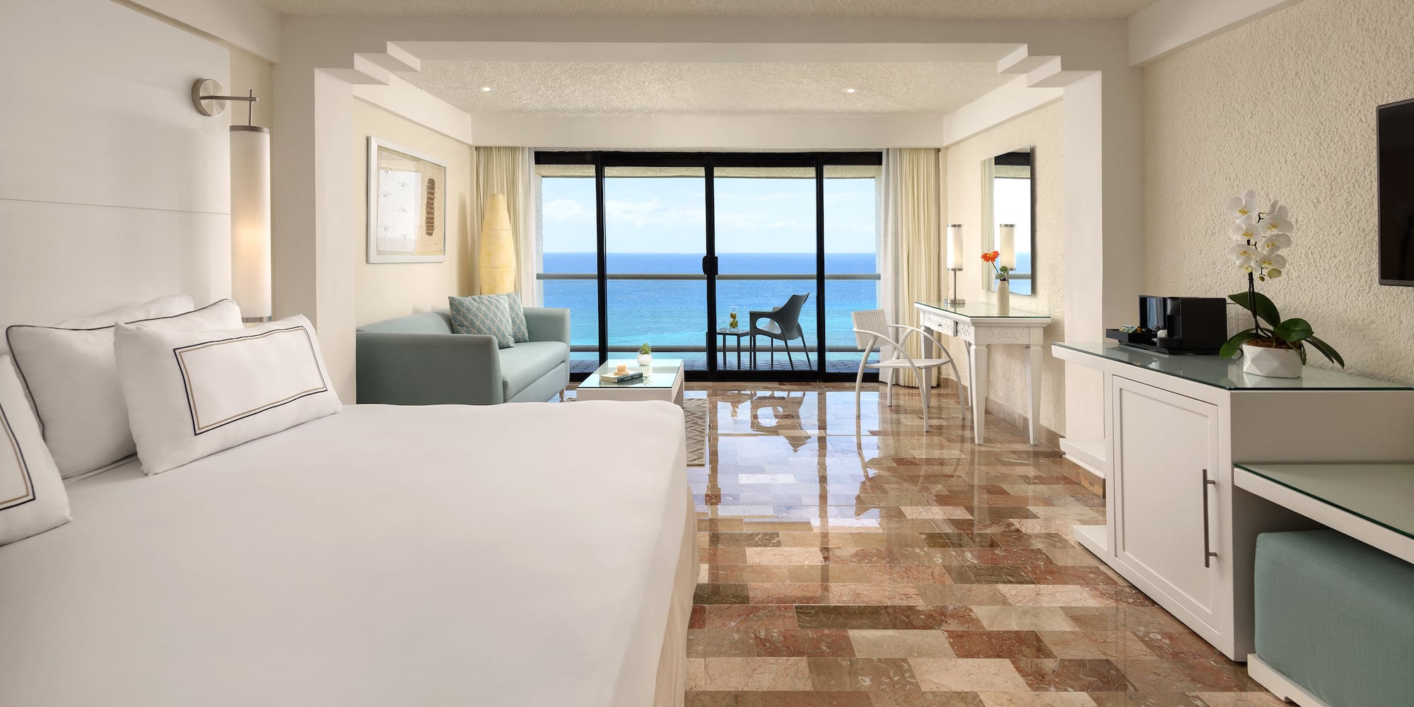 a room with a large bed and a glass door