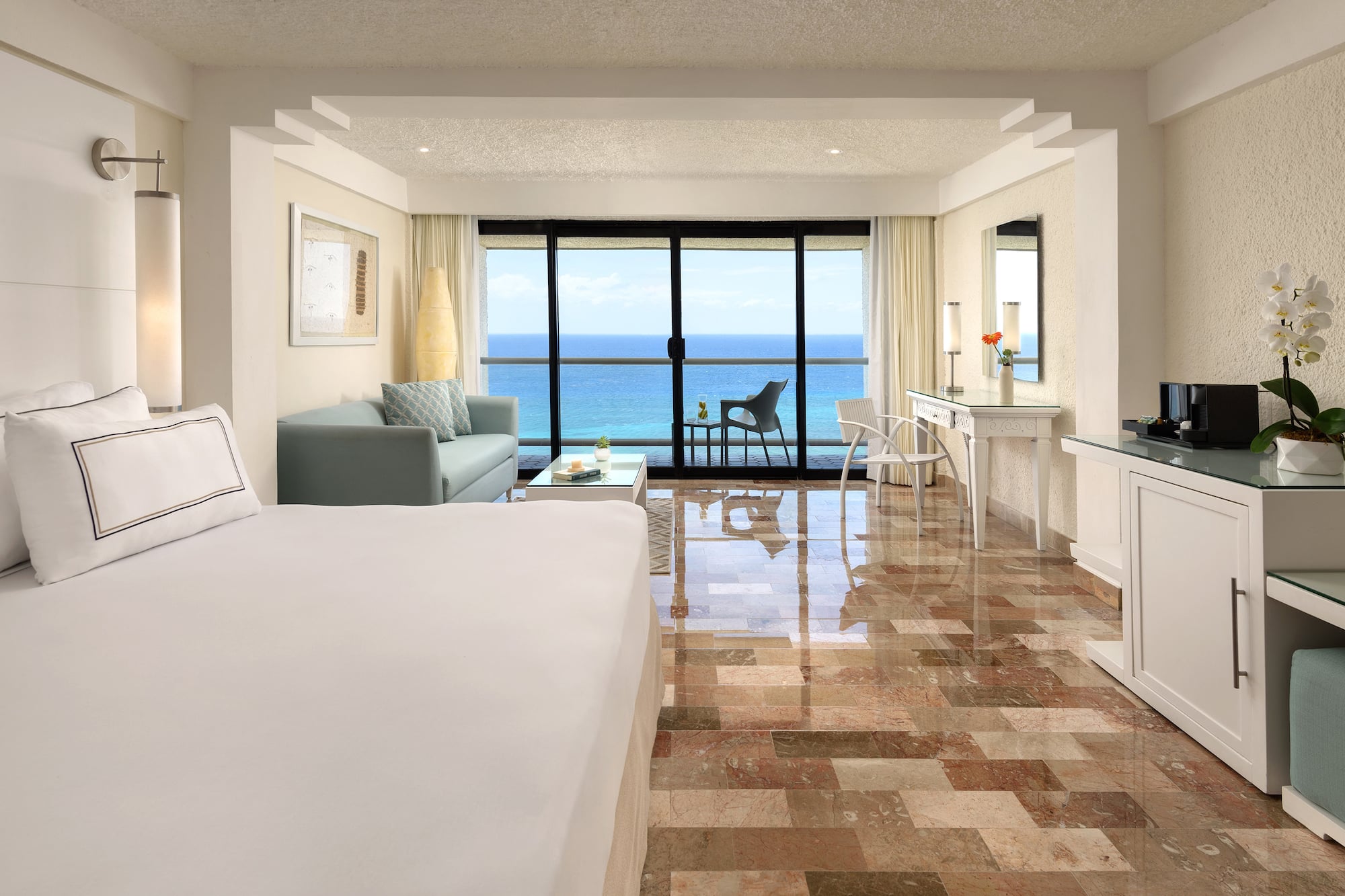 a room with a large bed and a glass door