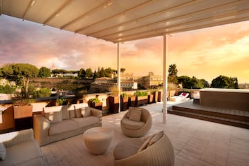 a patio with a covered patio and a view of a city