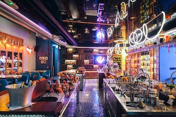a bar with many tables and chairs