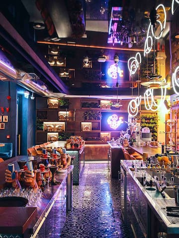 a bar with many tables and chairs