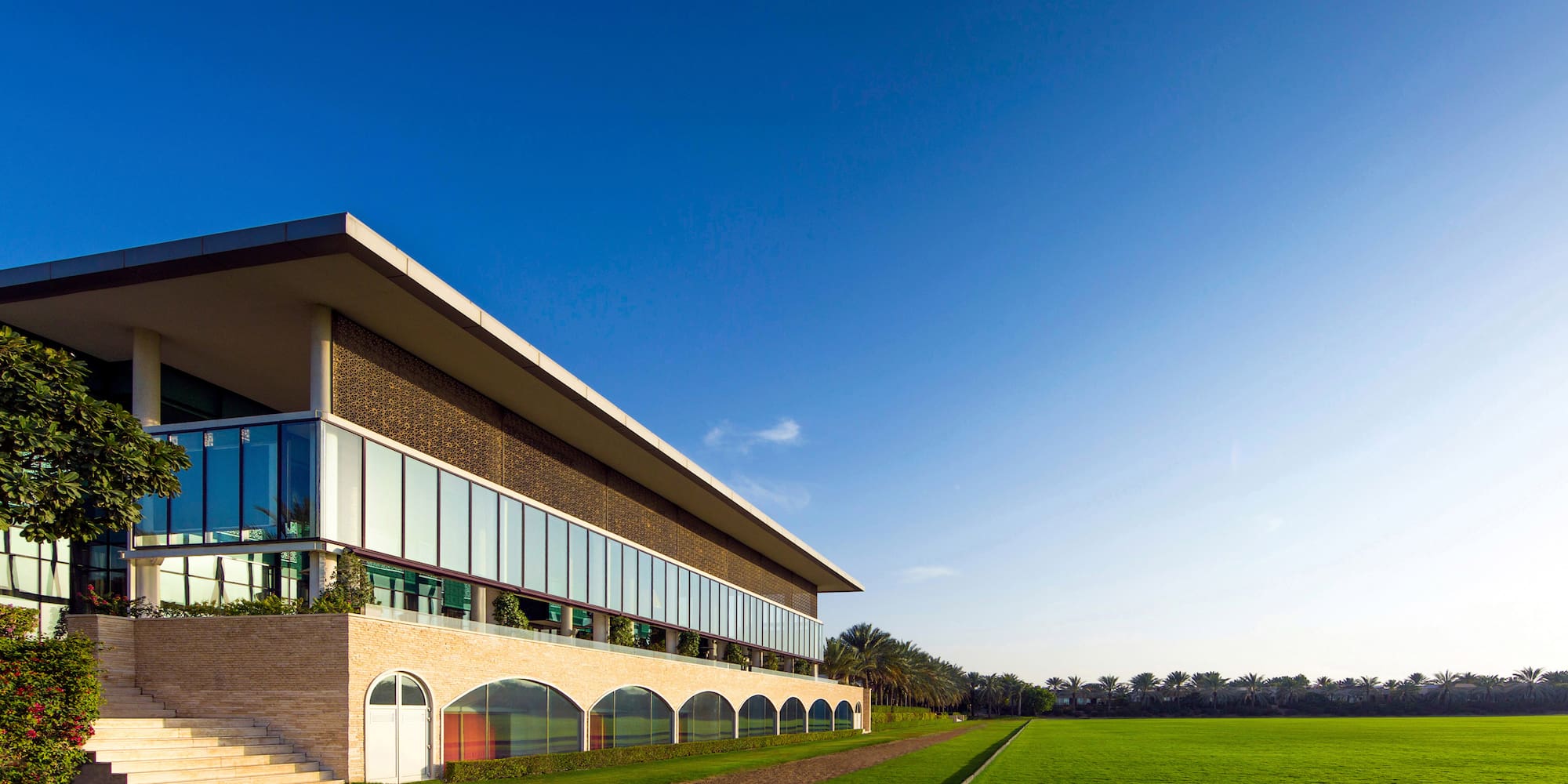 a building with a lawn and a blue sky