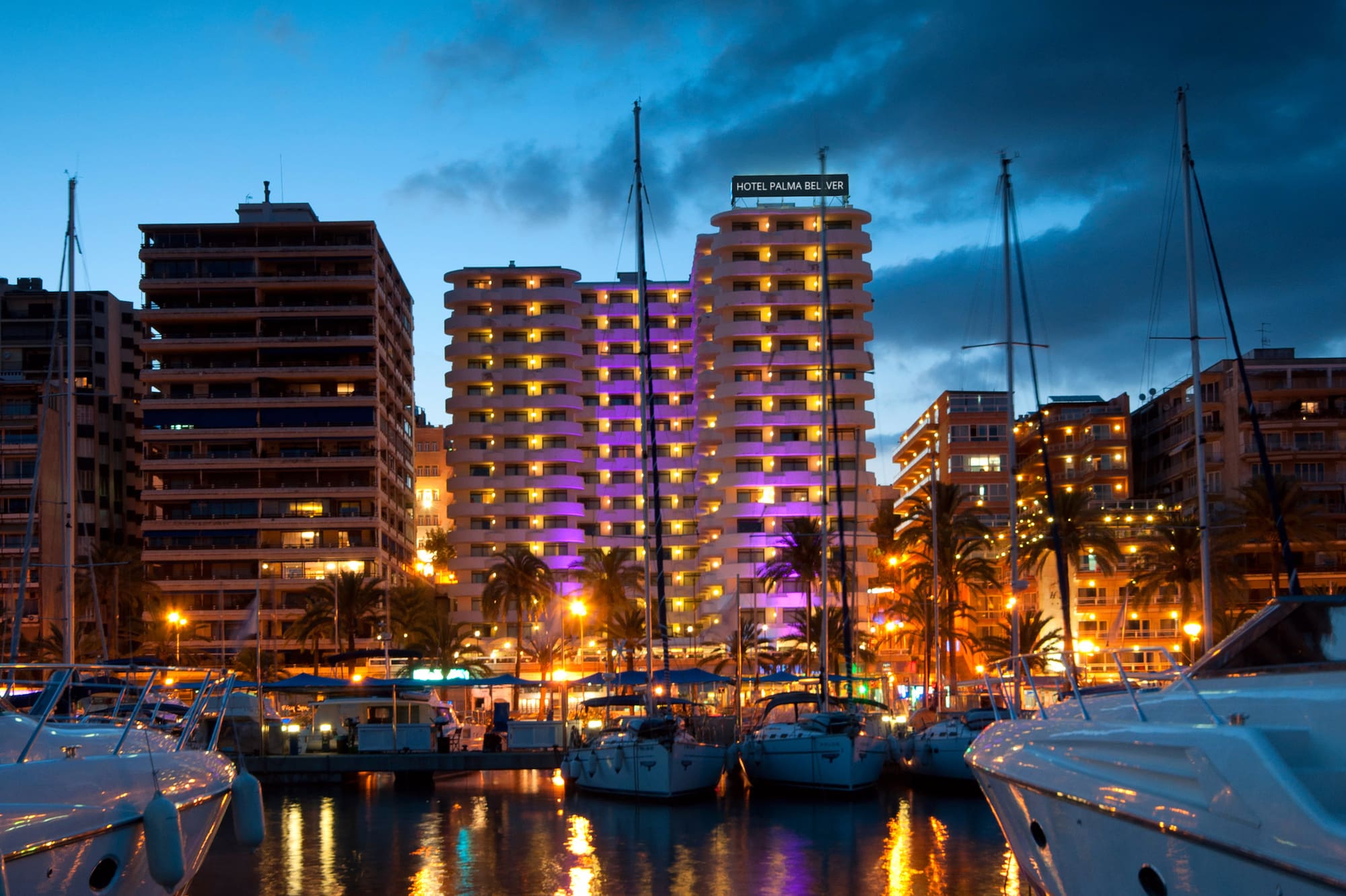 Palma de Mallorca marina at night, Hotel Palma Belver, yachts, city lights reflecting.