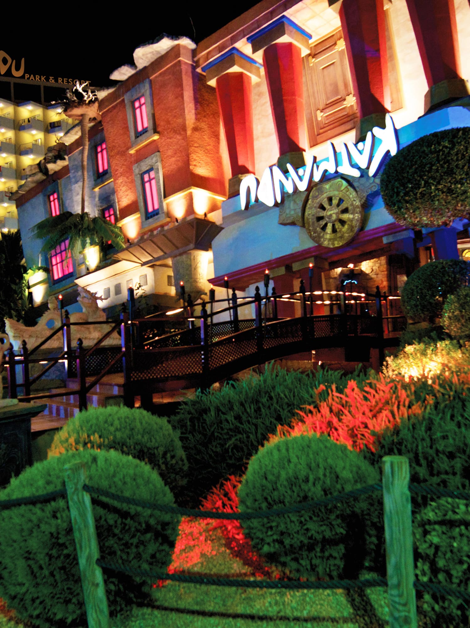 a building with a garden and bushes