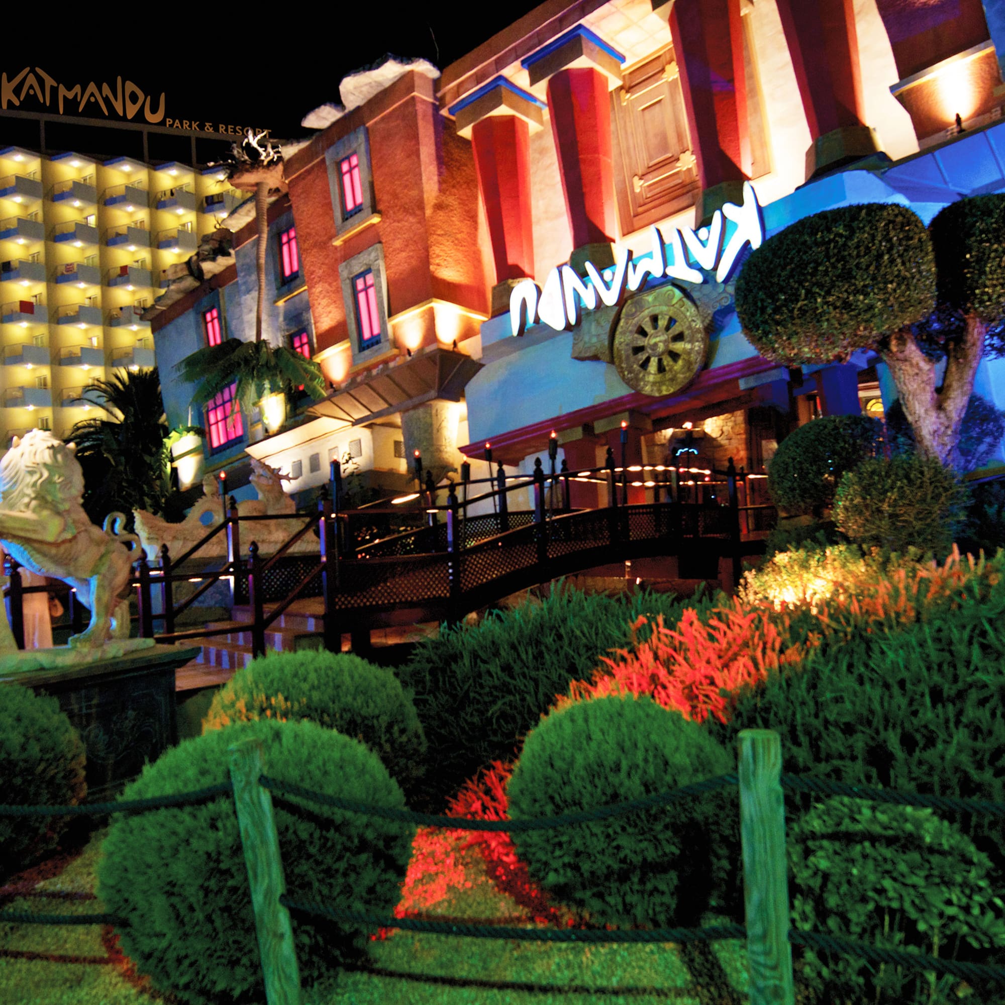 a building with a garden and bushes