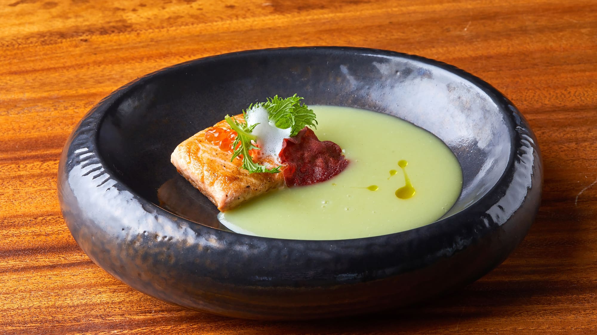 a black bowl with food in it