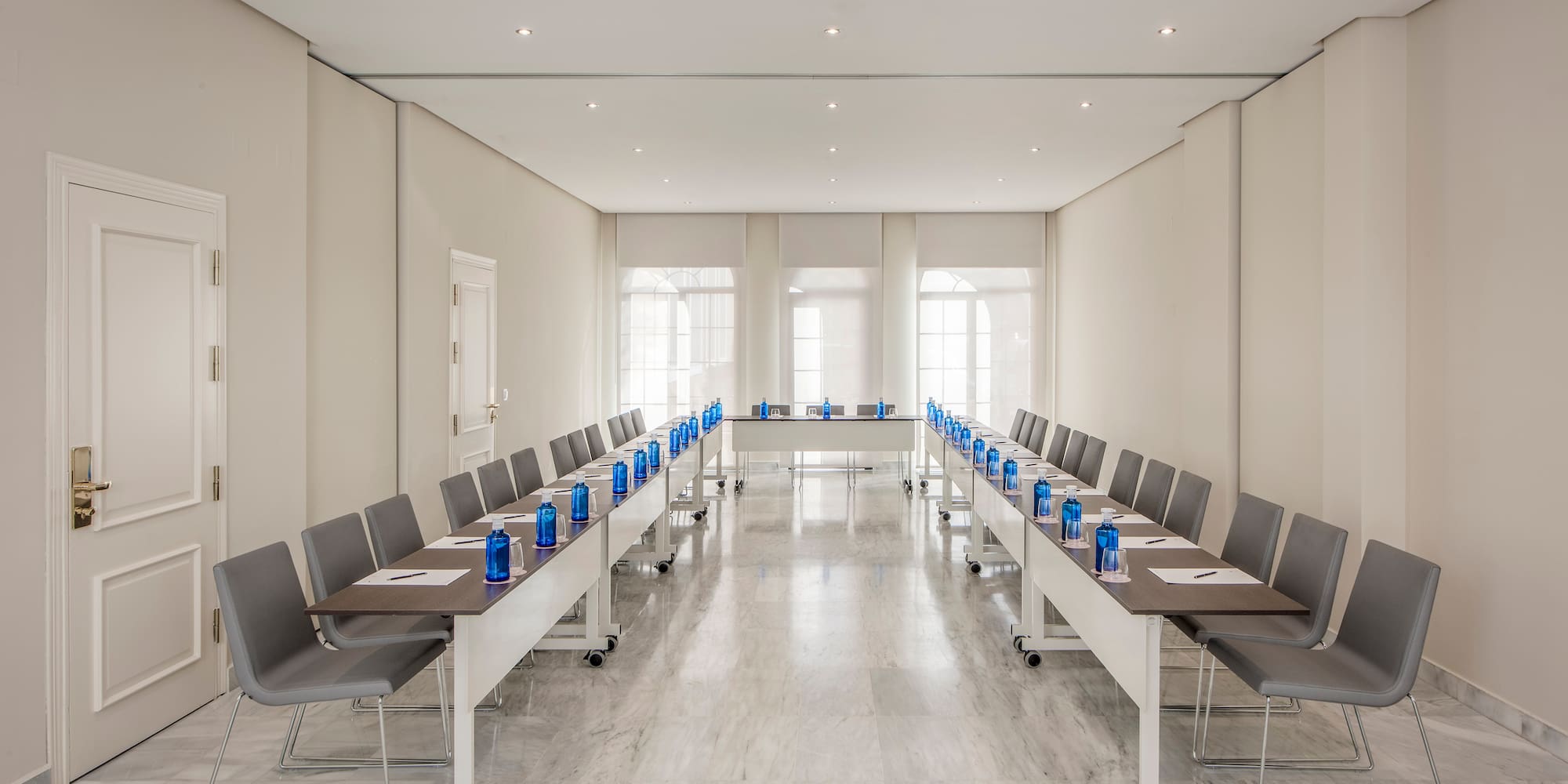 a room with long tables and chairs