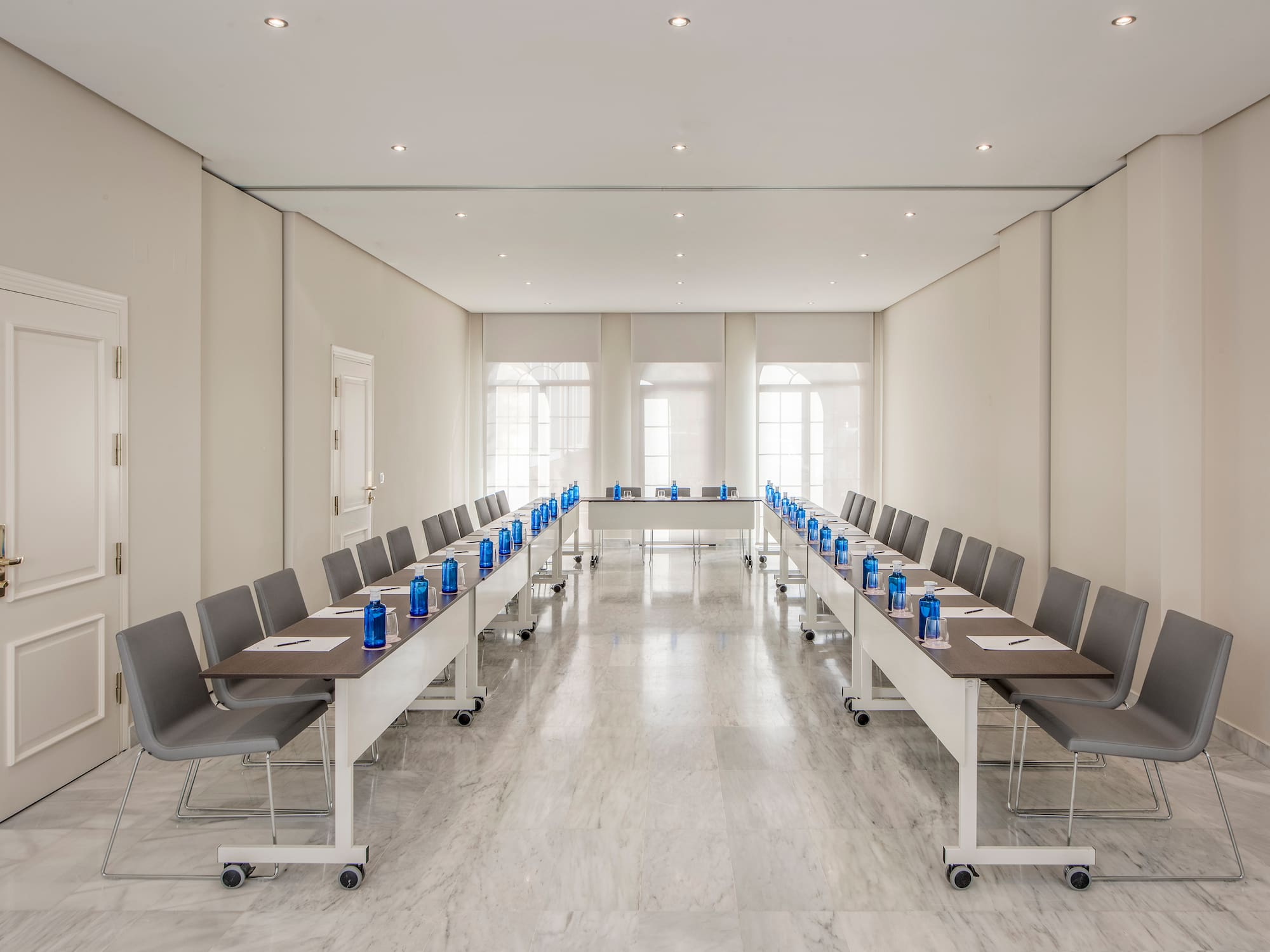 a room with long tables and chairs