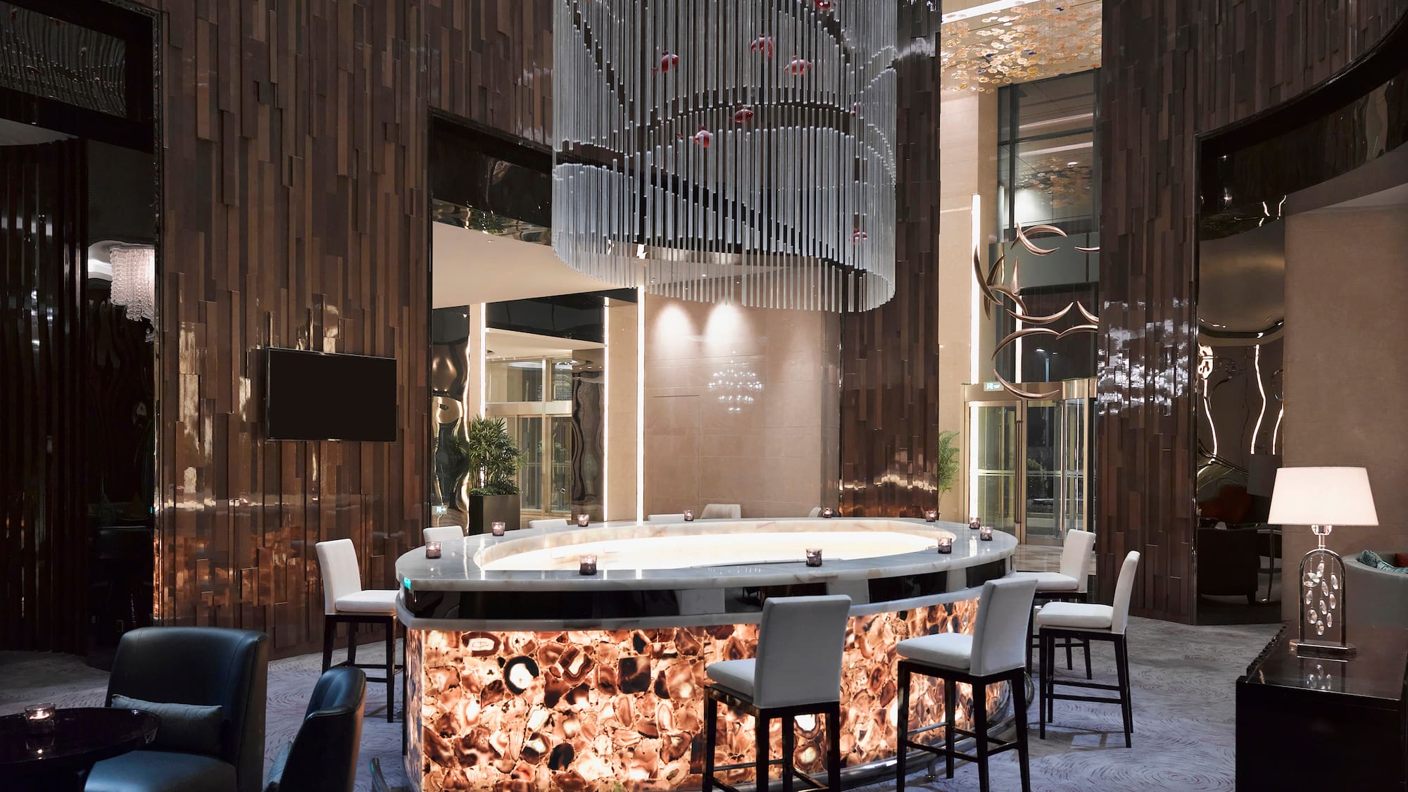 a bar with chairs and a chandelier