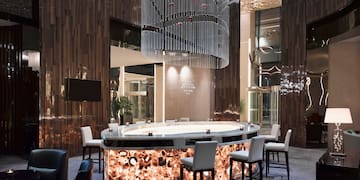 a bar with chairs and a chandelier