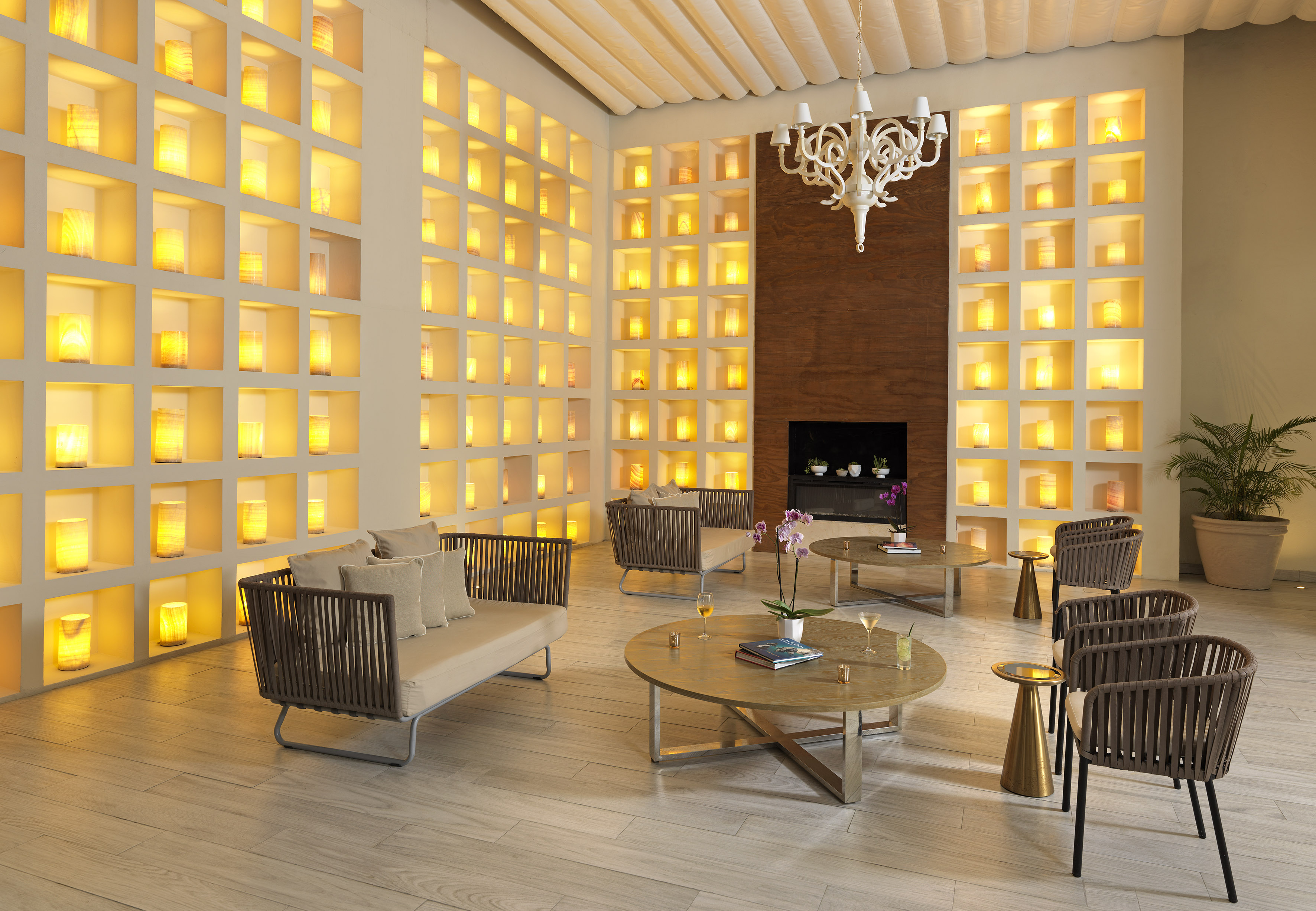 Lounge with warm wall niches, modern seating, and coffee tables.