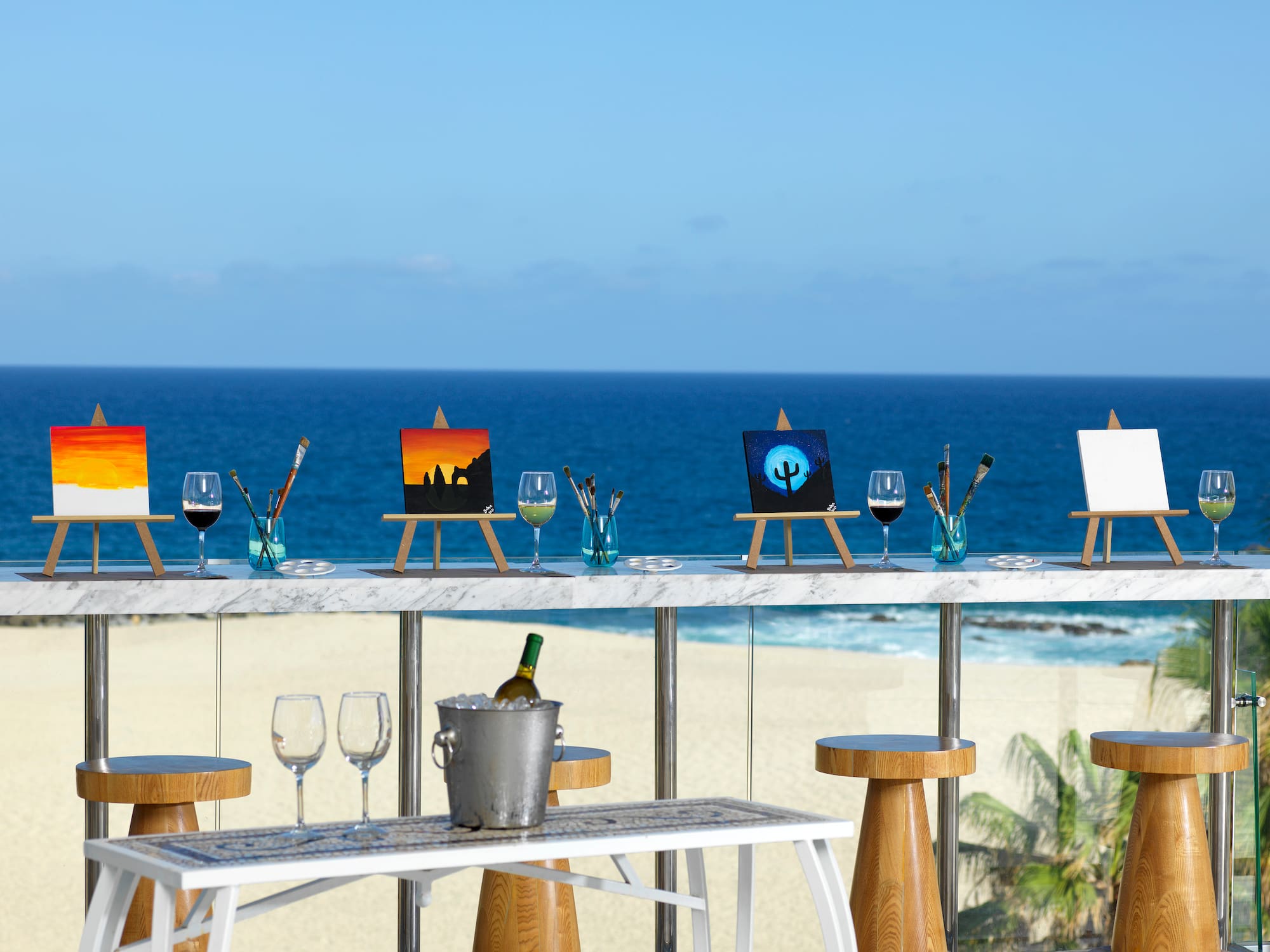 a table with art on it and a bucket of wine on it