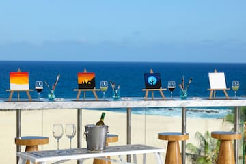 a table with art on it and a bucket of wine on it