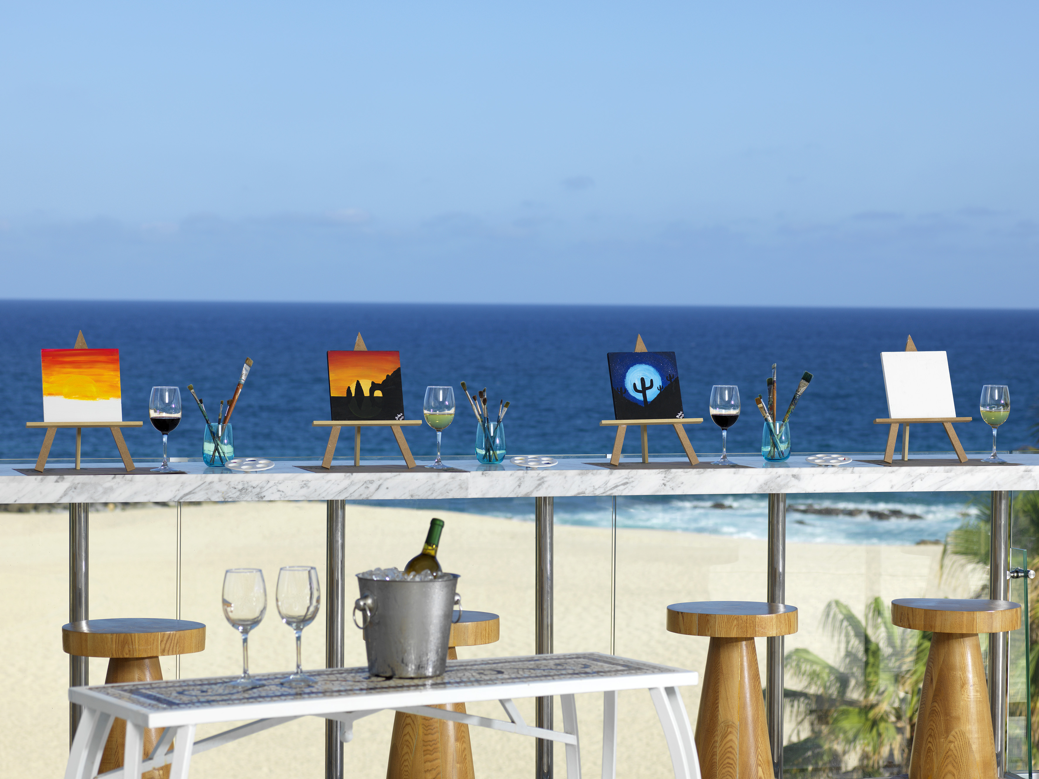 a table with art on it and a bucket of wine on it