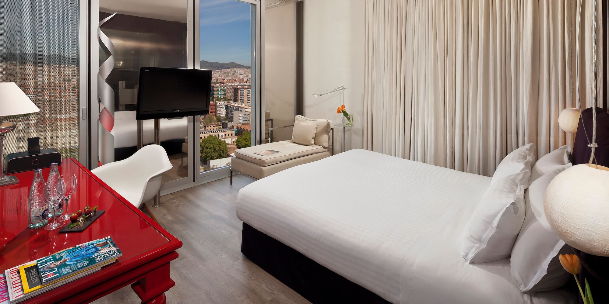 a bedroom with a red desk and a bed