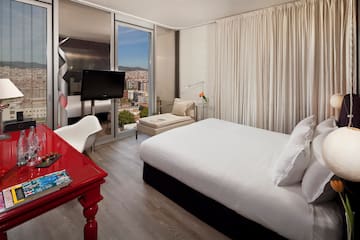a bedroom with a red desk and a bed