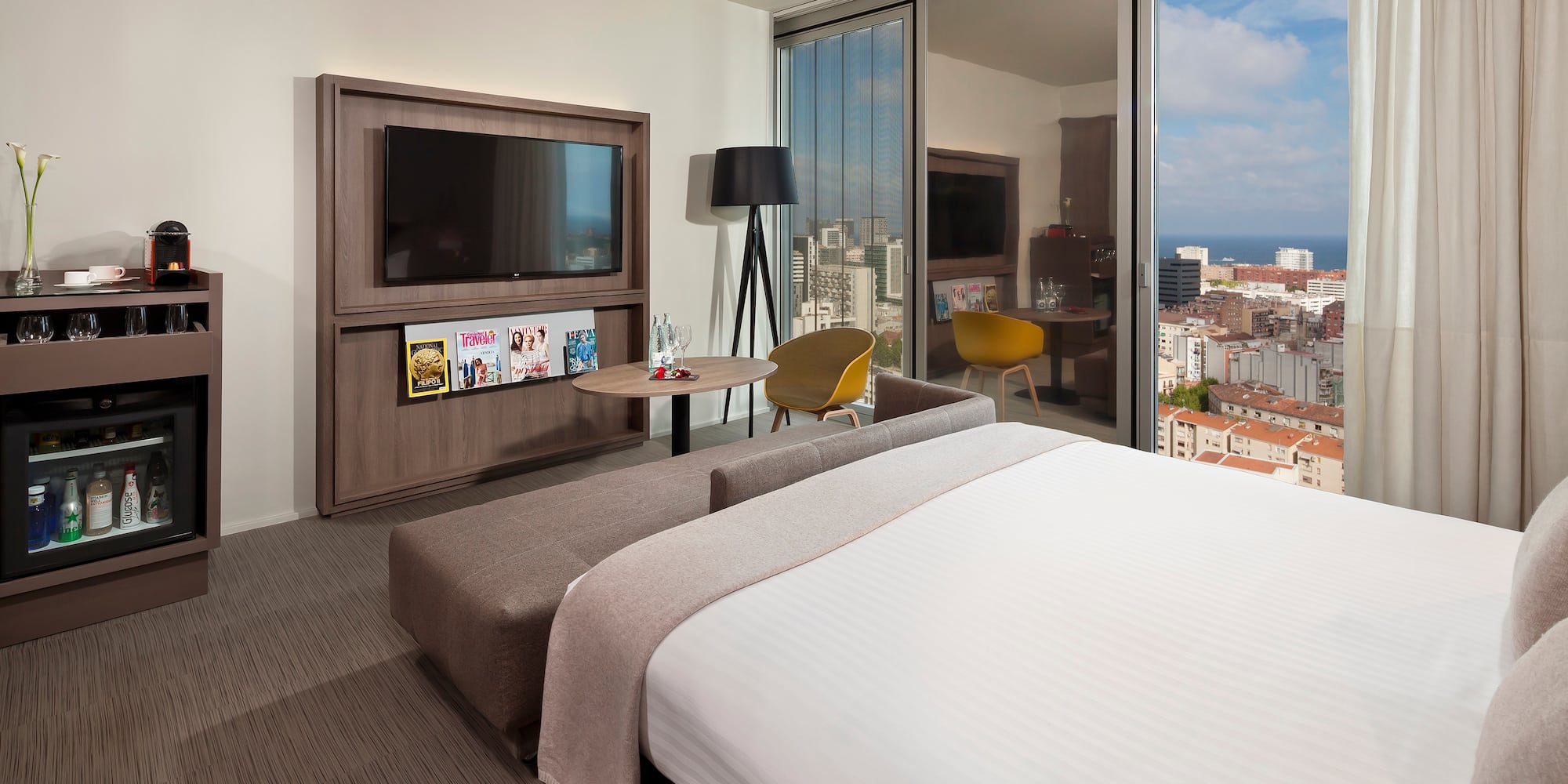 a bedroom with a large television and a large bed